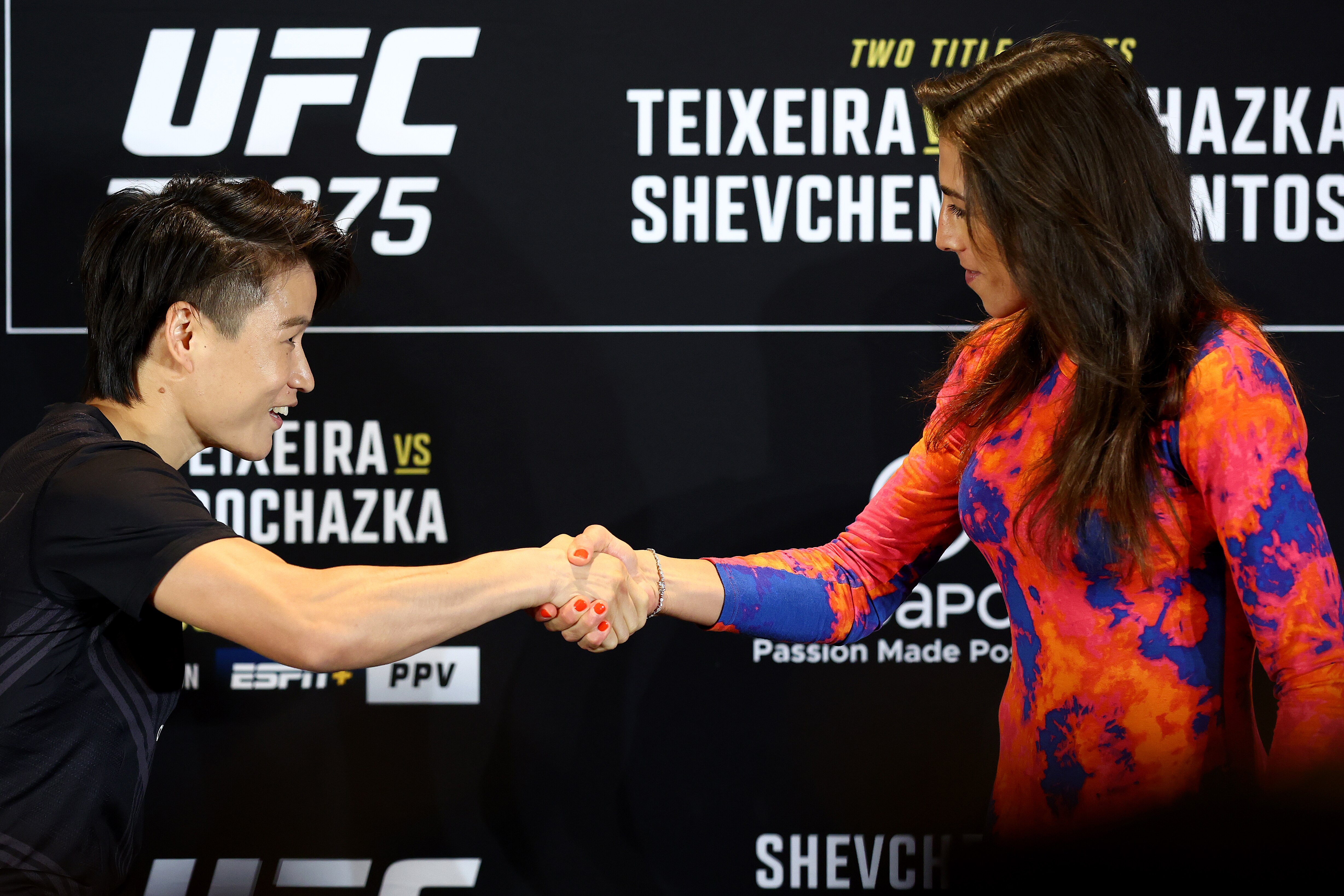 SINGAPORE, SINGAPORE - JUNE 08: Zhang Weili (L) of China and Joanna Jedrzejczyk of Poland shake hands ahead of their strawweight bout during UFC 275 Media Day at Mandarin Oriental on June 08, 2022 in Singapore. (Photo by Yong Teck Lim/Getty Images)