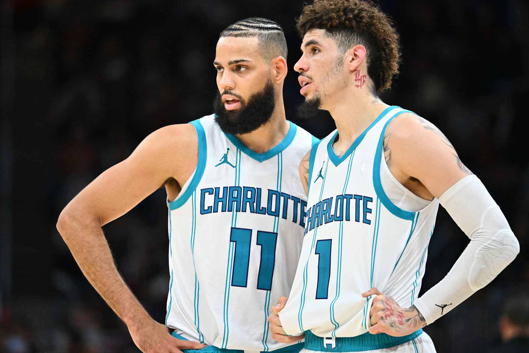CLEVELAND, OHIO - NOVEMBER 17: Cody Martin #11 talks with LaMelo Ball #1 of the Charlotte Hornets during the second half against the Cleveland Cavaliers at Rocket Mortgage Fieldhouse on November 17, 2024 in Cleveland, Ohio. The Cavaliers defeated the Hornets 128-114. NOTE TO USER: User expressly acknowledges and agrees that, by downloading and or using this photograph, User is consenting to the terms and conditions of the Getty Images License Agreement. (Photo by Jason Miller/Getty Images)
