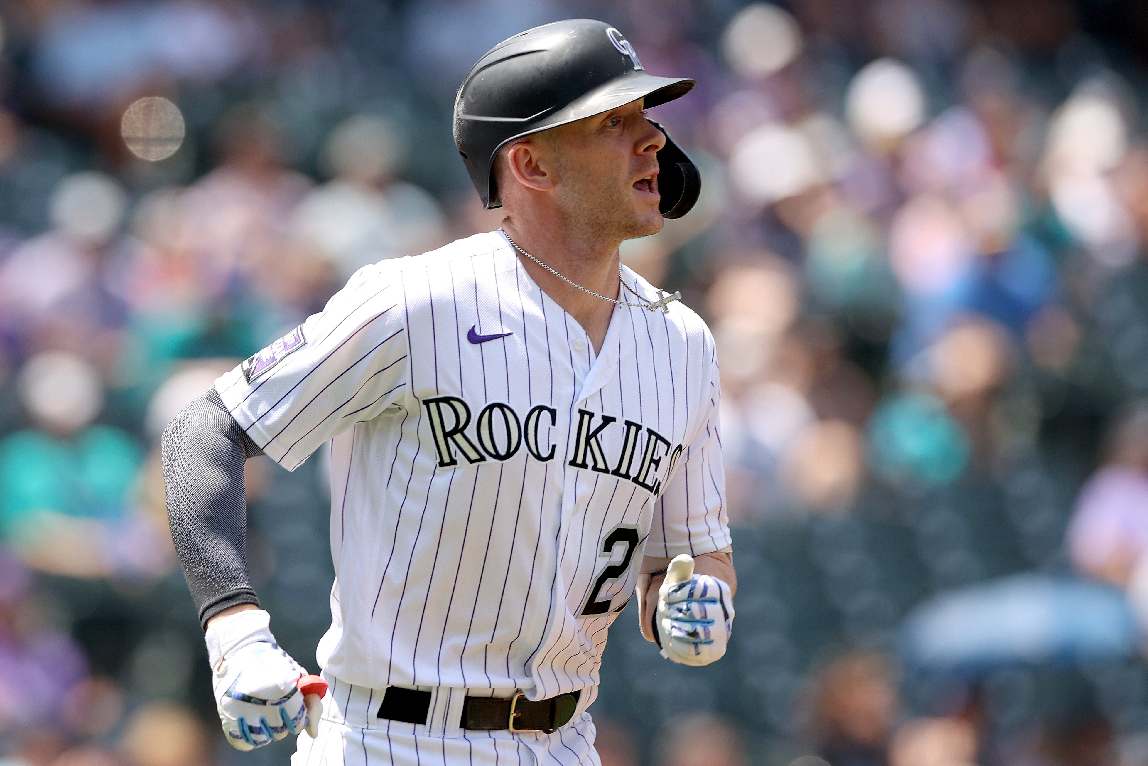 DENVER, COLORADO - JULY 21: Trevor Story #27 of the Colorado Rockies riuns to first after hitting a single against the Seattle Mariners in the first inning at Coors Field on July 21, 2021 in Denver, Colorado. (Photo by Matthew Stockman/Getty Images)
