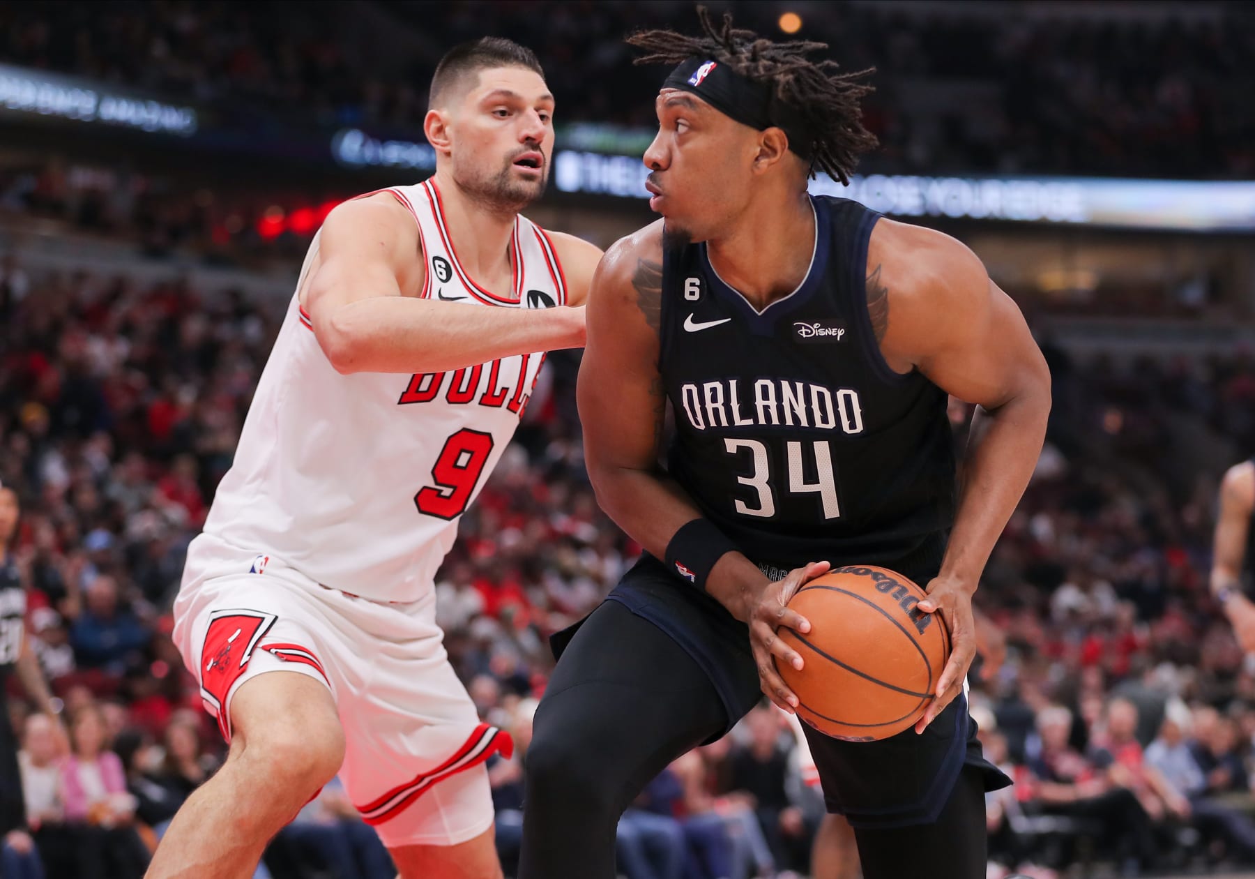 CHICAGO, IL - FEBRUARY 13: Chicago Bulls Center Nikola Vucevic (9) guards Orlando Magic Center Wendell Carter Jr. (34) during a NBA game between the Orlando  Magic and the Chicago Bulls on February 13, 2023 at the United Center in Chicago, IL. (Photo by Melissa Tamez/Icon Sportswire via Getty Images)