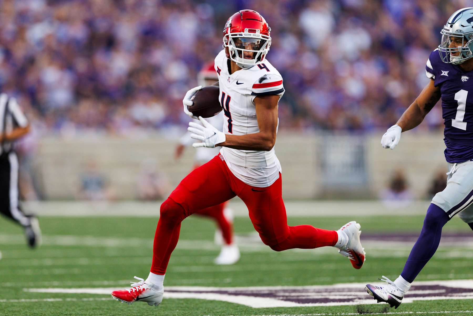 MANHATTAN, KANSAS - SEPTEMBER 13: Tetairoa McMillan #4 of the Arizona Wildcats runs after the catch during a game against Kansas State Wildcats at Bill Snyder Family Football Stadium on September 13, 2024 in Manhattan, Kansas. (Photo by Ric Tapia/Getty Images)