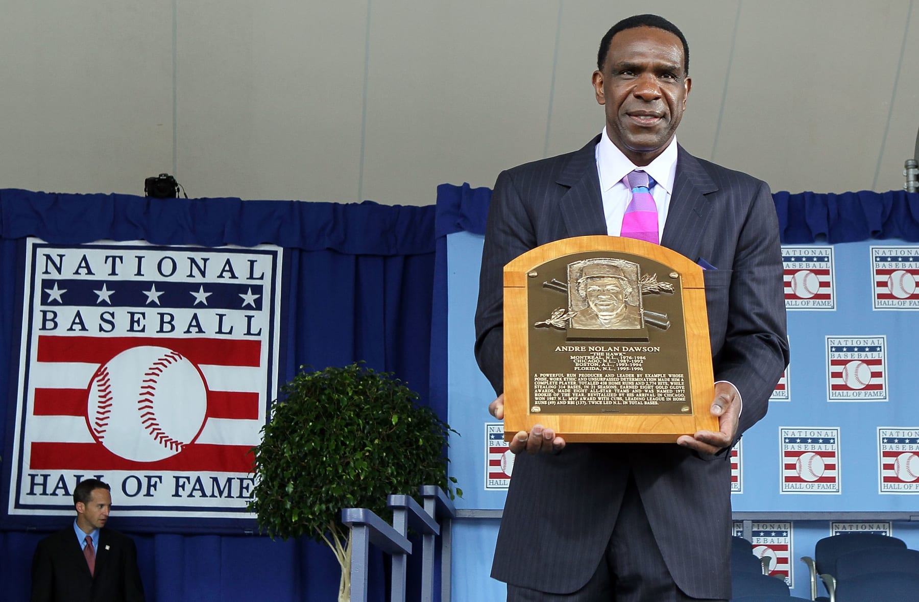 COOPERSTOWN, NY - JULY 25:  2010 inductee Andre Dawson poses for a photograph with his plaque at Clark Sports Center during the Baseball Hall of Fame induction ceremony on July 25, 20010 in Cooperstown, New York. Dawson was an eight time all-star during his twenty one year career finishing with 438 home runs, 1,591 runs batted in, and 314 stolen bases.Dawson was also the National League Rookie of the Year in 1977 with Montreal as well as the National League MVP in 1987 with Chicago.  (Photo by Jim McIsaac/Getty Images)