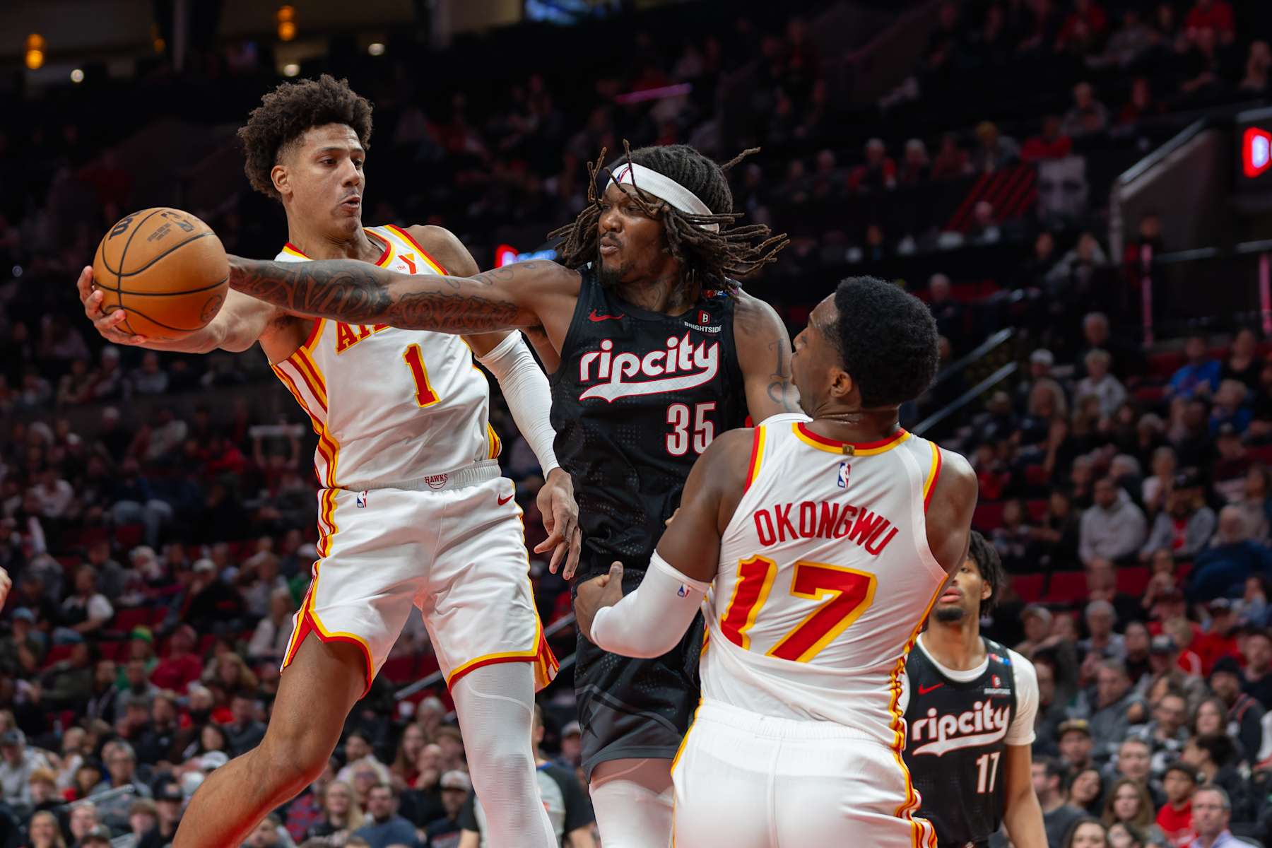 PORTLAND, OREGON - NOVEMBER 17: Jalen Johnson #1 of the Atlanta Hawks drives against Robert Williams III of the Portland Trail Blazers at Moda Center on November 17, 2024 in Portland, Oregon. The Trailblazers defeated the Hawks 114-110. NOTE TO USER: User expressly acknowledges and agrees that, by downloading and or using this photograph, User is consenting to the terms and conditions of the Getty Images License Agreement. (Photo by Tom Hauck/Getty Images)