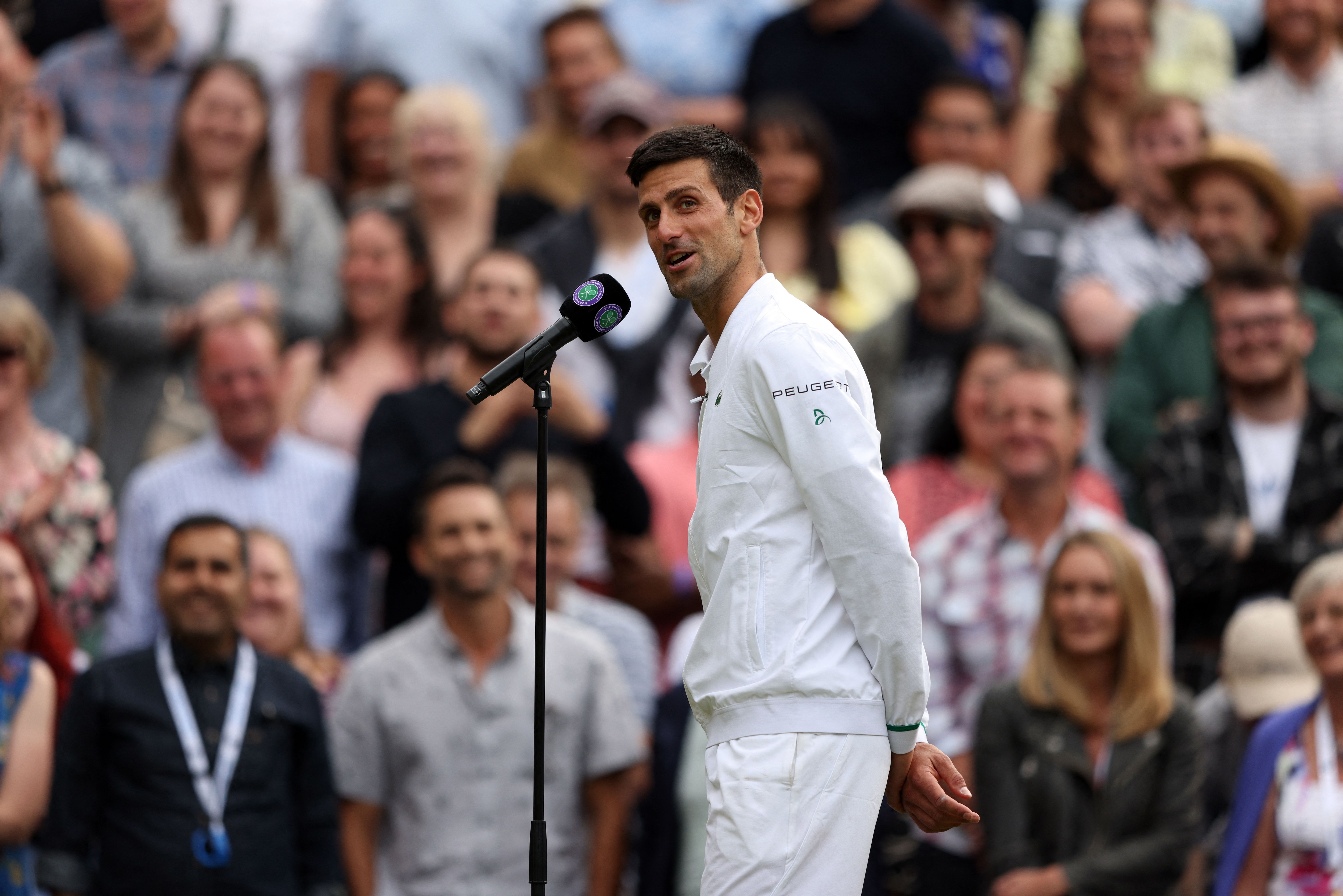 Serbia's Novak Djokovic speaks after winning against Canada's Denis Shapovalov during their men's singles semi-final match on the eleventh day of the 2021 Wimbledon Championships at The All England Tennis Club in Wimbledon, southwest London, on July 9, 2021. - RESTRICTED TO EDITORIAL USE (Photo by Adrian DENNIS / AFP) / RESTRICTED TO EDITORIAL USE (Photo by ADRIAN DENNIS/AFP via Getty Images)