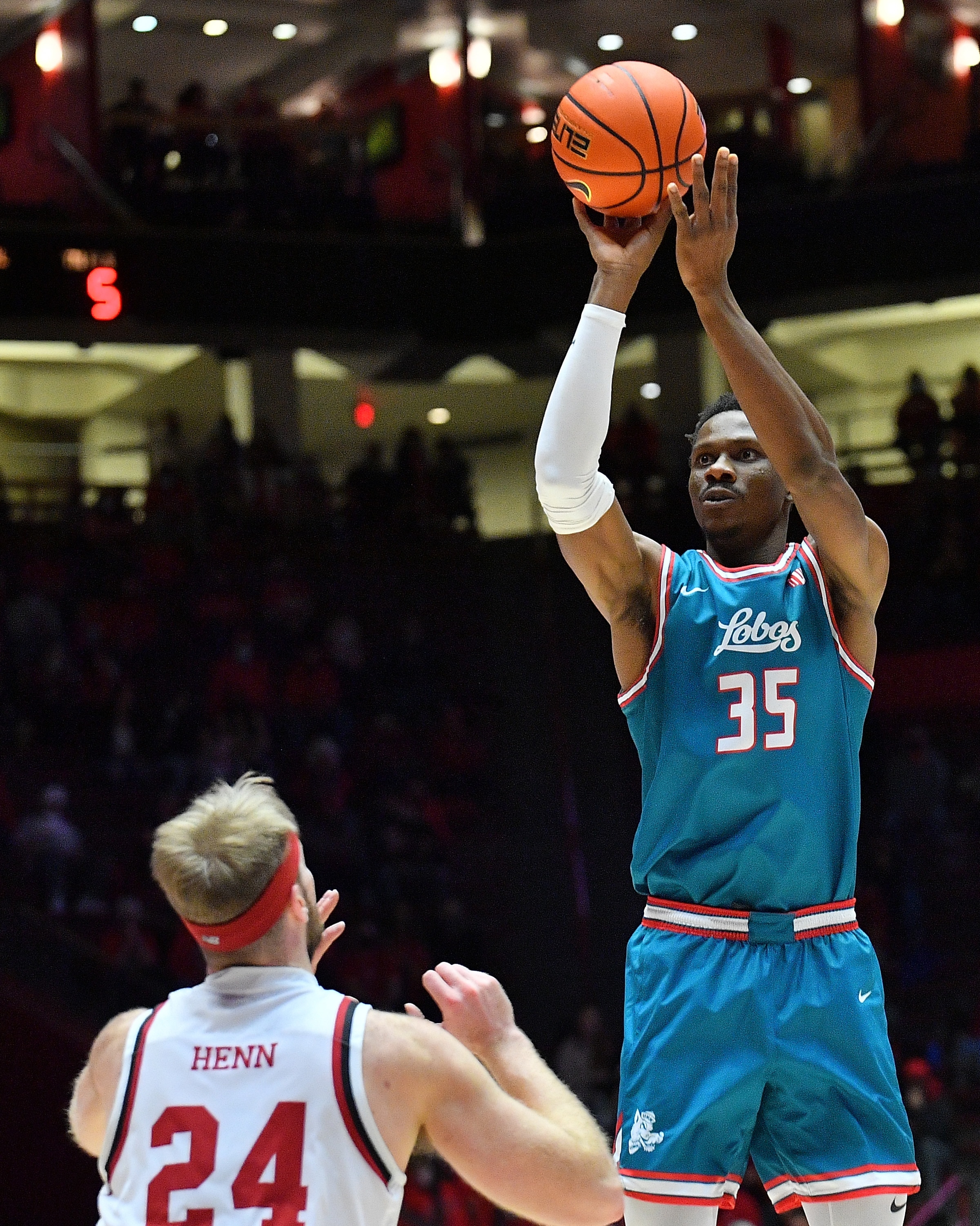 ALBUQUERQUE, NEW MEXICO - DECEMBER 09: Gethro Muscadin #35 of the New Mexico Lobos shoots against Michael Henn #24 of the Denver Pioneers during their game at The Pit on December 09, 2021 in Albuquerque, New Mexico. (Photo by Sam Wasson/Getty Images)