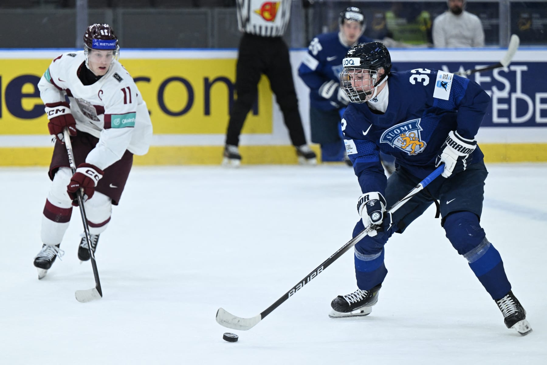 Latvia's Dans Locmelis (L) vies for the puck with Finland's Emil Hemming during the Group A ice hockey match between Latvia and Finland of the IIHF World Junior Championship in Gothenburg, Sweden on December 29, 2023. (Photo by Bjorn LARSSON ROSVALL / TT NEWS AGENCY / AFP) / Sweden OUT (Photo by BJORN LARSSON ROSVALL/TT NEWS AGENCY/AFP via Getty Images)