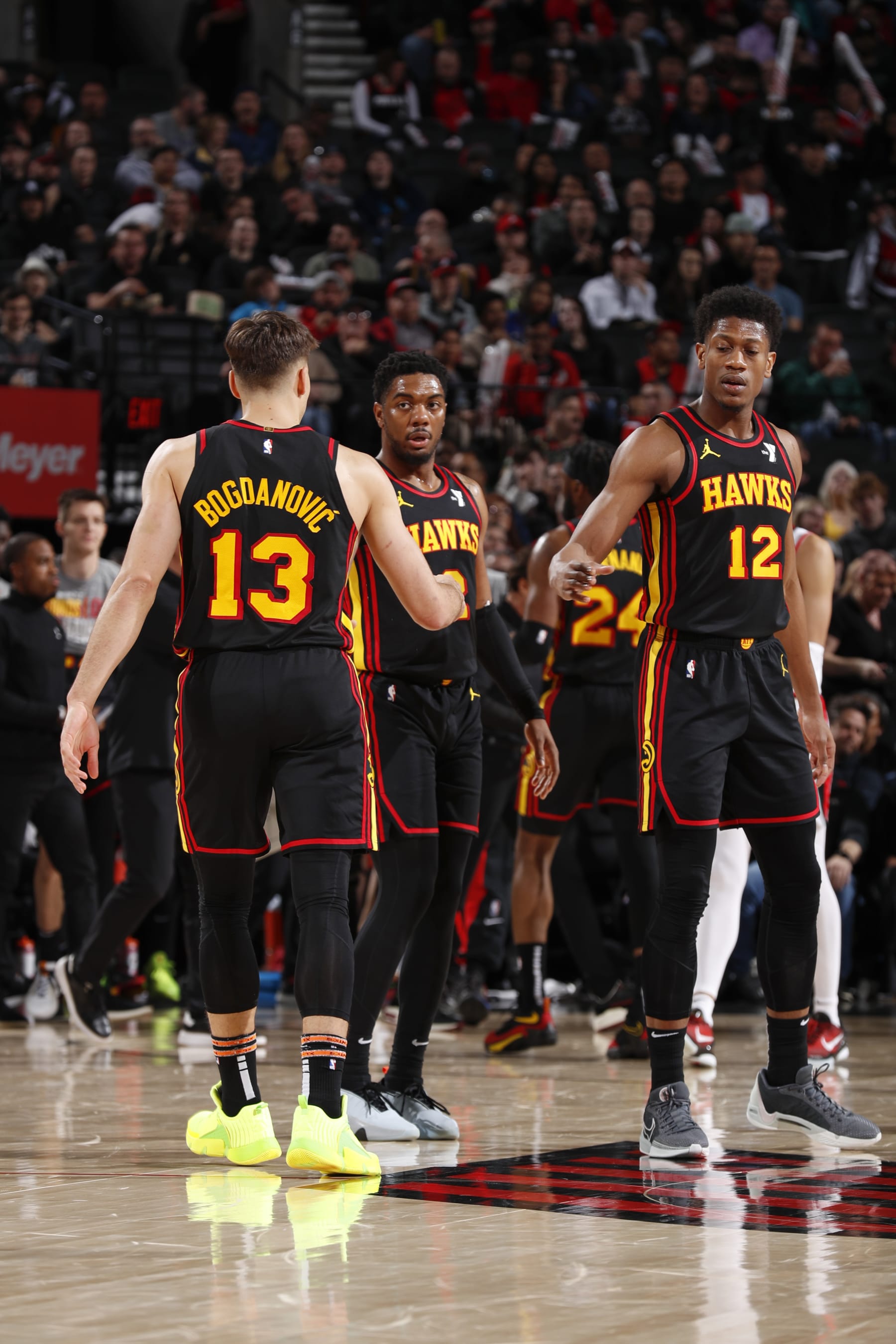 PORTLAND, OR - MARCH 13:  Bogdan Bogdanovic #13 of the Atlanta Hawks De'Andre Hunter #12 of the Atlanta Hawks & Trent Forrest #2 of the Atlanta Hawks high five during the game  on March 13, 2024 at the Moda Center Arena in Portland, Oregon. NOTE TO USER: User expressly acknowledges and agrees that, by downloading and or using this photograph, user is consenting to the terms and conditions of the Getty Images License Agreement. Mandatory Copyright Notice: Copyright 2024 NBAE (Photo by Cameron Browne/NBAE via Getty Images)