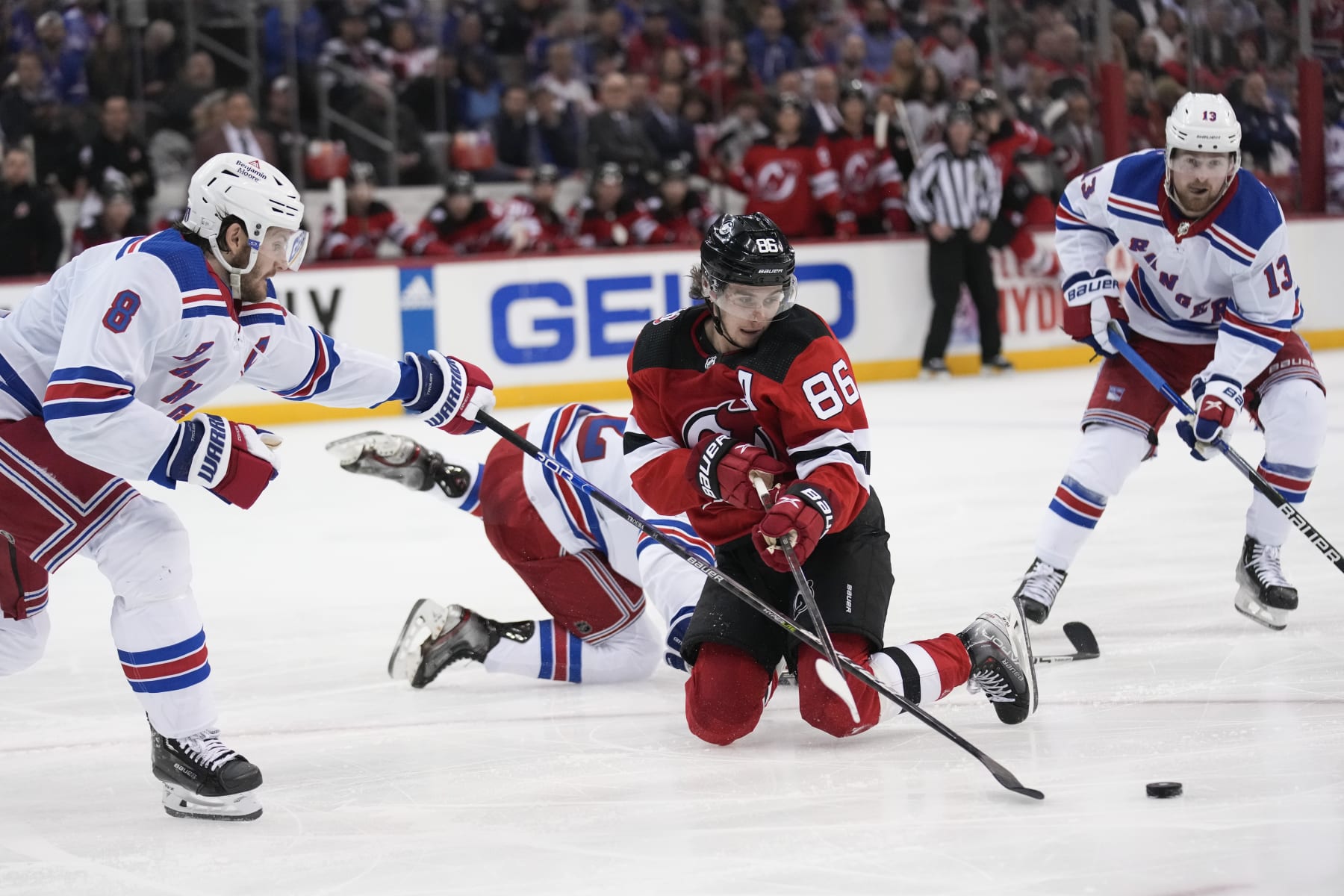 New Jersey Devils' Jack Hughes (86) tries to keep control of the puck during the second period against the New York Rangers in Game 2 of an NHL hockey Stanley Cup first-round playoff series in Newark, N.J., Thursday, April 20, 2023. (AP Photo/Seth Wenig)