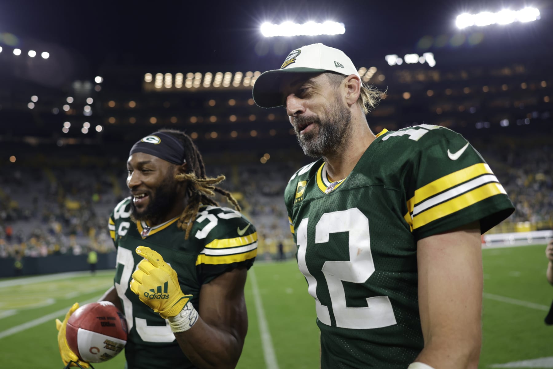 Green Bay Packers quarterback Aaron Rodgers (12) walks off the field with teammate running back Aaron Jones (33) after an NFL football game against the Chicago Bears Sunday, Sept. 18, 2022, in Green Bay, Wis. The Packers won 27-10. (AP Photo/Matt Ludtke)