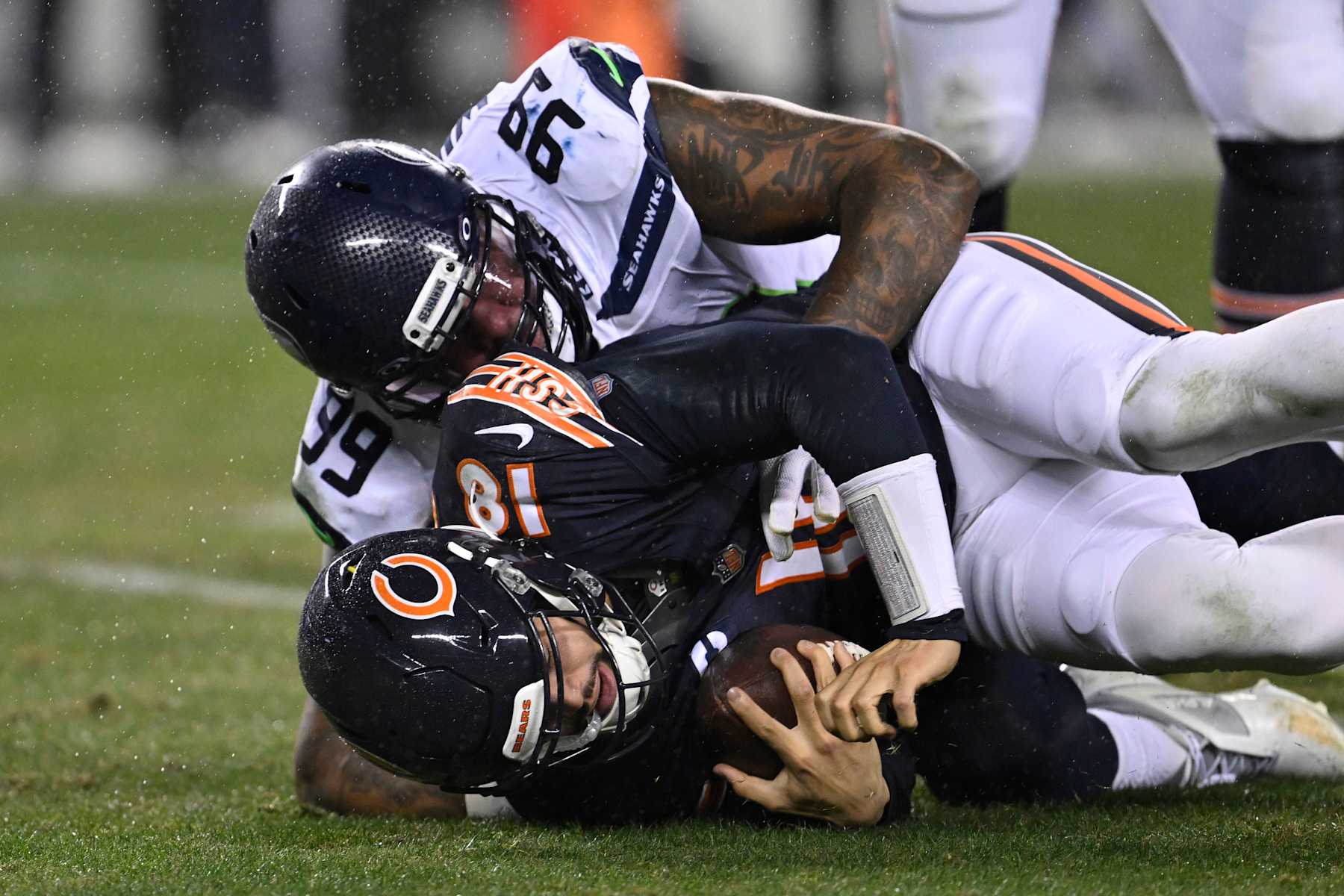 Seattle Seahawks defensive lineman Leonard Williams sacks Chicago Bears quarterback Caleb Williams.