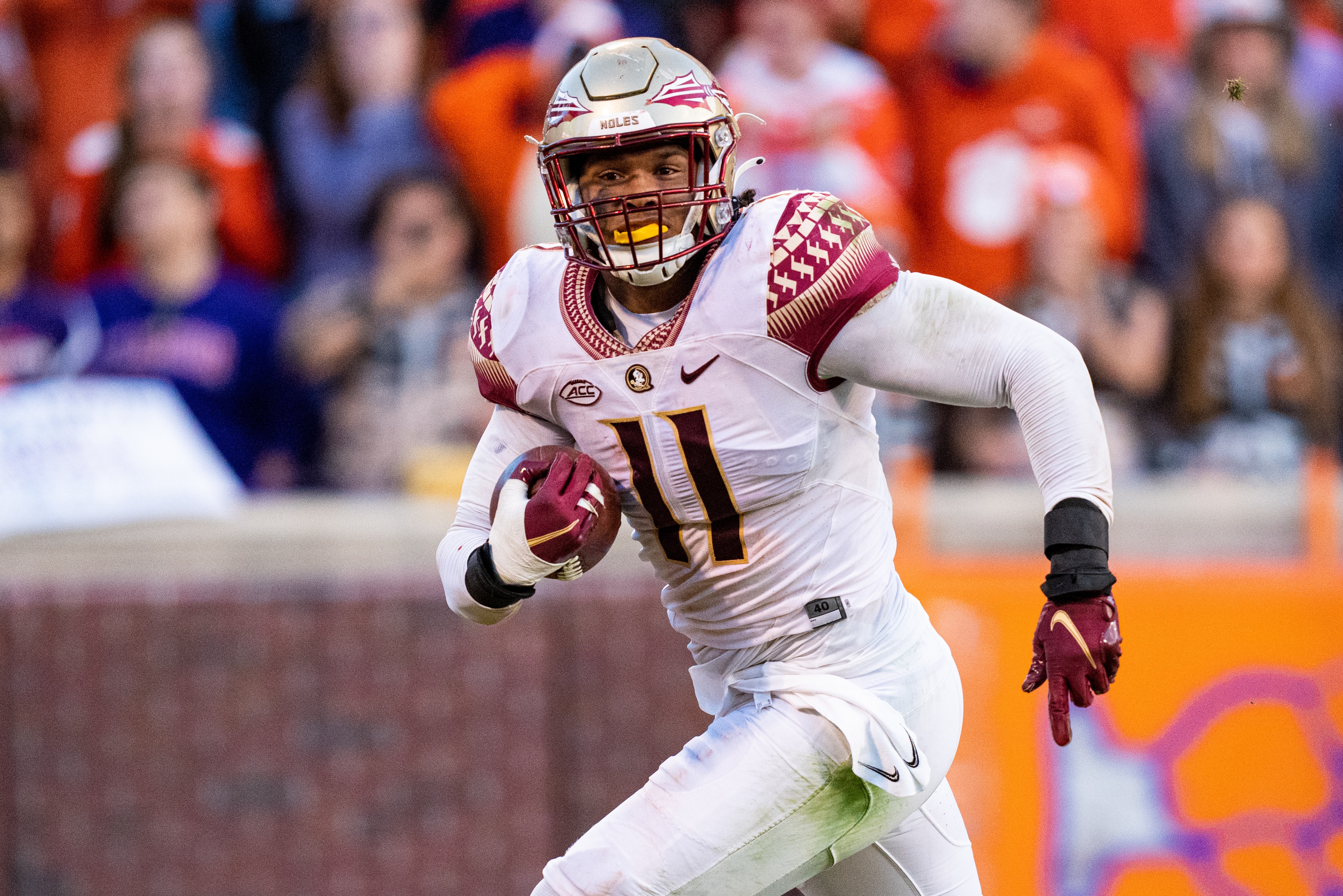 CLEMSON, SOUTH CAROLINA - OCTOBER 30: Defensive end Jermaine Johnson II #11 of the Florida State Seminoles scores a defensive touchdown against the Clemson Tigers during their game at Clemson Memorial Stadium on October 30, 2021 in Clemson, South Carolina. (Photo by Jacob Kupferman/Getty Images)