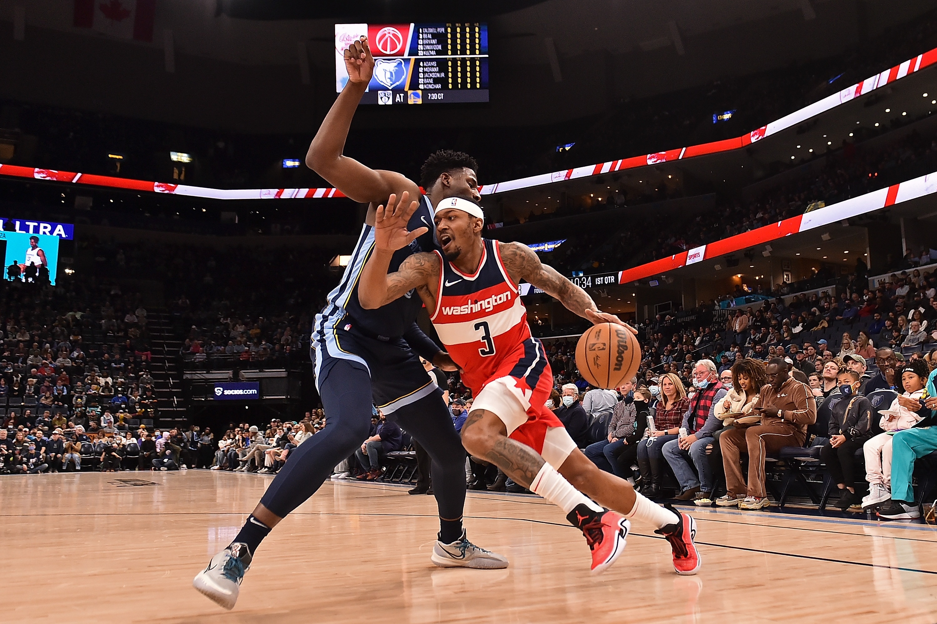 MEMPHIS, TENNESSEE - JANUARY 29: Bradley Beal #3 of the Washington Wizards drives against Jaren Jackson Jr. #13 of the Memphis Grizzlies during the first half  at FedExForum on January 29, 2022 in Memphis, Tennessee. NOTE TO USER: User expressly acknowledges and agrees that, by downloading and or using this photograph, User is consenting to the terms and conditions of the Getty Images License Agreement. (Photo by Justin Ford/Getty Images)