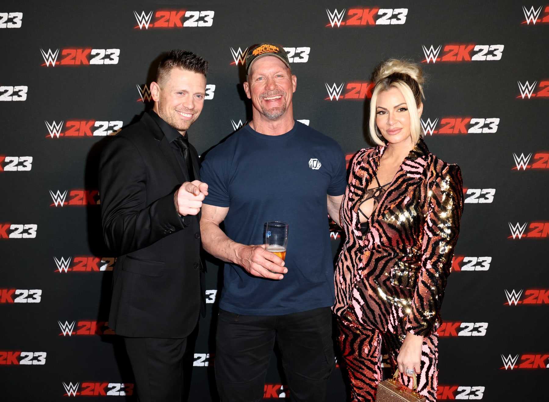 EL SEGUNDO, CALIFORNIA - MARCH 16: (L-R) The Miz, "Stone Cold" Steve Austin and Maryse Ouellet attend WWE 2K23 Launch Event at El Segundo Brewing Company on March 16, 2023 in El Segundo, California. (Photo by Joe Scarnici/Getty Images for 2K )