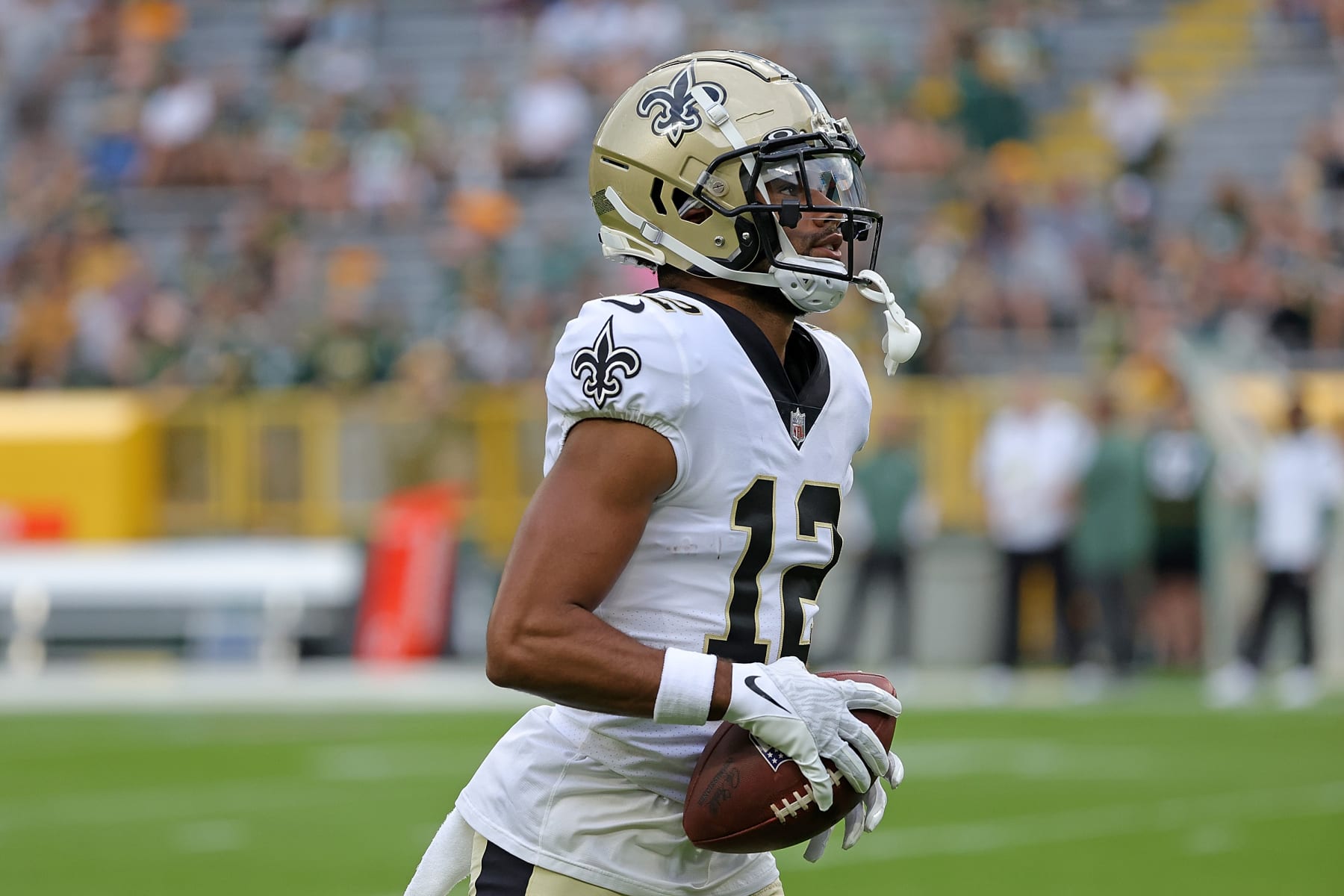 GREEN BAY, WISCONSIN - AUGUST 19: Chris Olave #12 of the New Orleans Saints participates in warmups prior to a preseason game against the Green Bay Packers at Lambeau Field on August 19, 2022 in Green Bay, Wisconsin. (Photo by Stacy Revere/Getty Images)