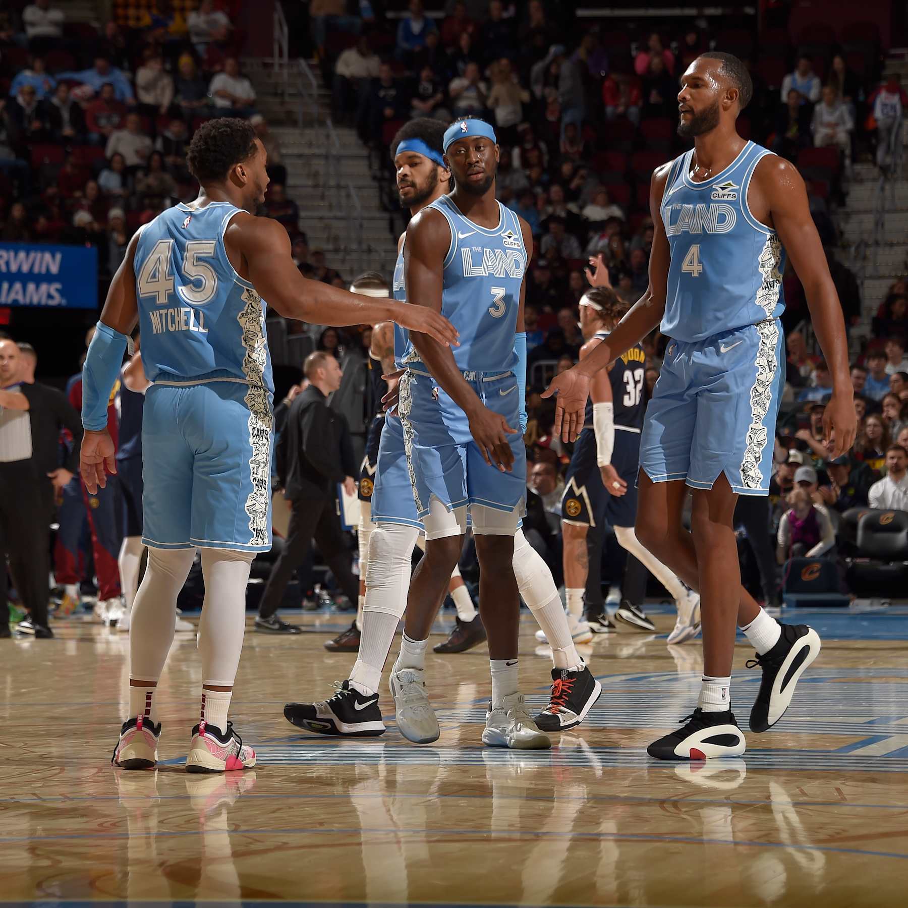 CLEVELAND, OH - DECEMBER 8:  Donovan Mitchell #45 and Evan Mobley #4 of the Cleveland Cavaliers high five during the game against the Denver Nuggets on December 5, 2024 at Rocket Mortgage FieldHouse in Cleveland, Ohio. NOTE TO USER: User expressly acknowledges and agrees that, by downloading and/or using this Photograph, user is consenting to the terms and conditions of the Getty Images License Agreement. Mandatory Copyright Notice: Copyright 2024 NBAE (Photo by David Liam Kyle/NBAE via Getty Images)