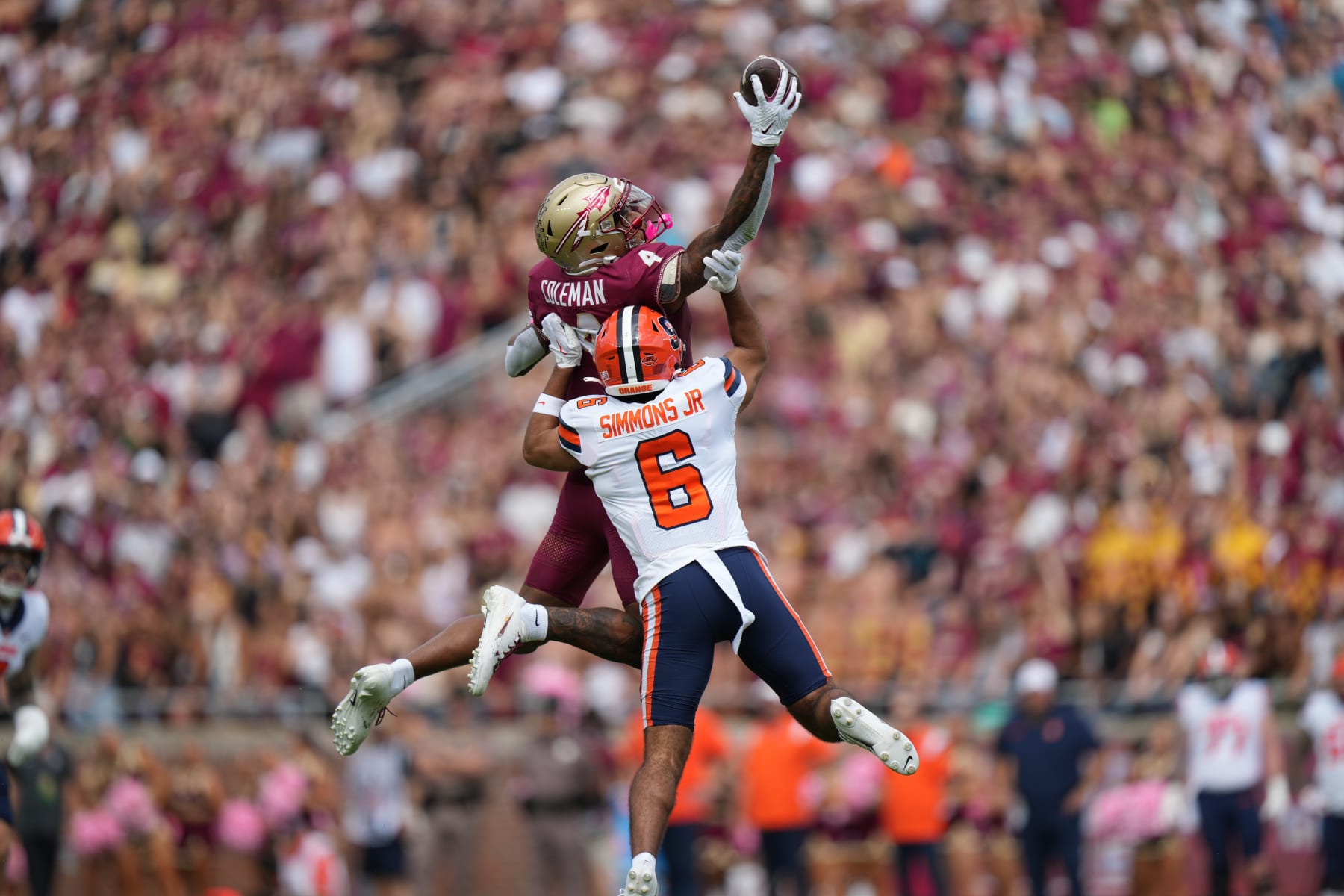 TALLAHASSEE, FL - OCTOBER 14:Florida State Seminoles wide receiver Keon Coleman (4) makes a leaping one handed catch over Syracuse Orange defensive back Jason Simmons Jr. (6) in the first half during the game between the Syracuse Orange and the Florida State Seminoles on Saturday, October 14, 2023 at Bobby Bowden Field at Doak Campbell Stadium, Tallahassee, Fla. (Photo by Peter Joneleit/Icon Sportswire via Getty Images)