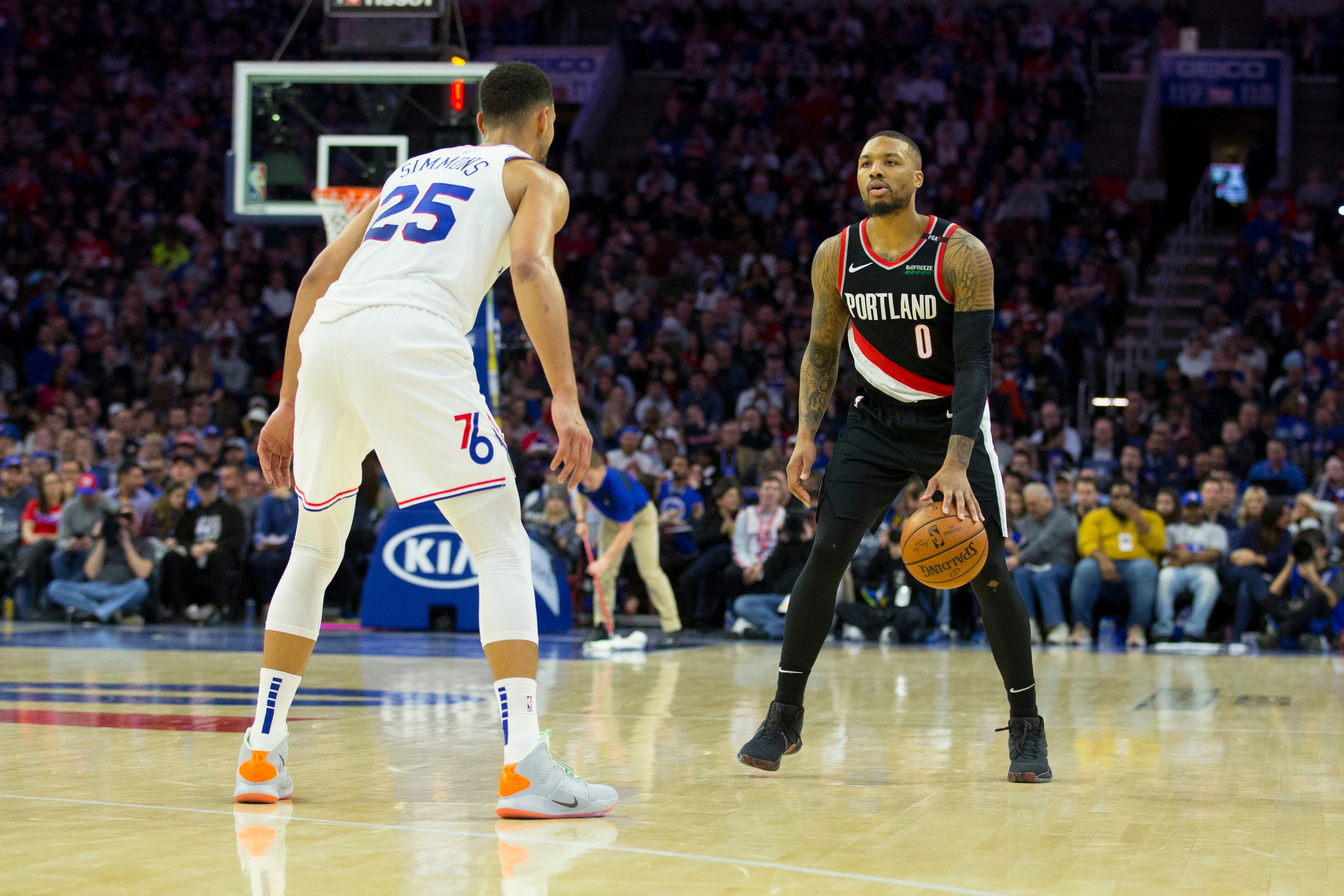 PHILADELPHIA, PA - FEBRUARY 23: Damian Lillard #0 of the Portland Trail Blazers dribbles the ball against Ben Simmons #25 of the Philadelphia 76ers in the second quarter at the Wells Fargo Center on February 23, 2019 in Philadelphia, Pennsylvania. NOTE TO USER: User expressly acknowledges and agrees that, by downloading and or using this photograph, User is consenting to the terms and conditions of the Getty Images License Agreement. (Photo by Mitchell Leff/Getty Images)