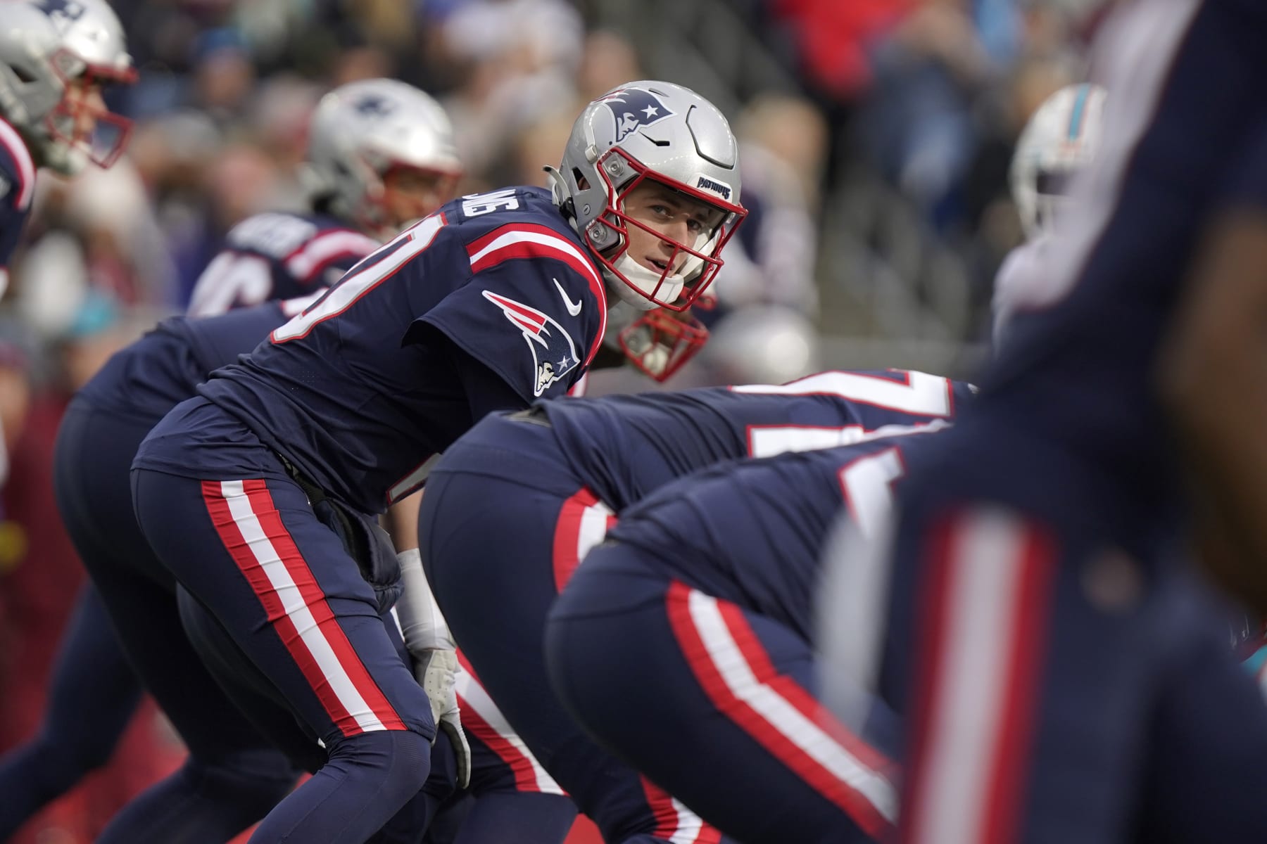 New England Patriots quarterback Mac Jones, center, in the first half of an NFL football game against the Miami Dolphins, Sunday, Jan. 1, 2023, in Foxborough, Mass. (AP Photo/Steven Senne)