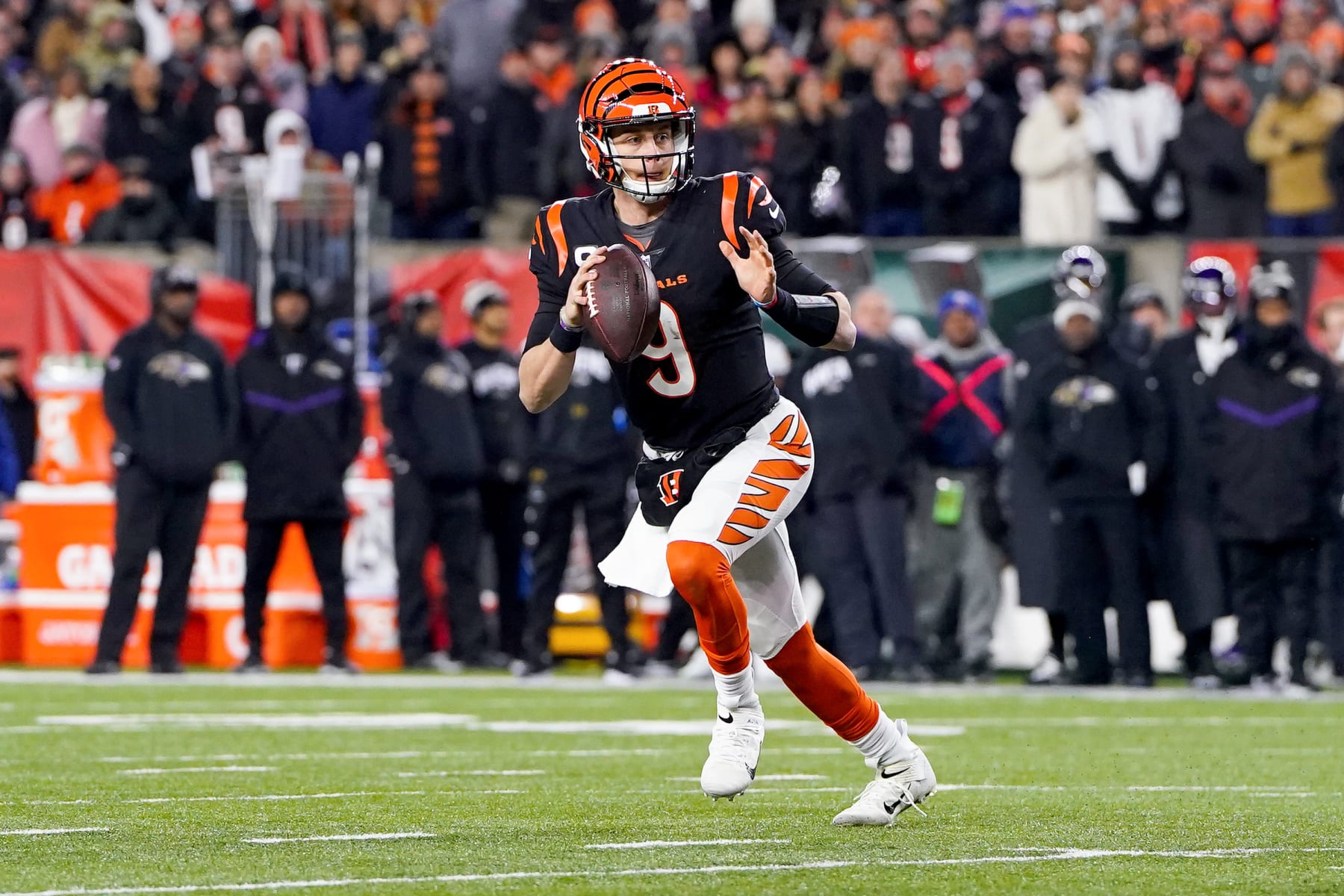 CINCINNATI, OHIO - JANUARY 15: Joe Burrow #9 of the Cincinnati Bengals looks to pass against the Baltimore Ravens during the first quarter in the AFC Wild Card playoff game at Paycor Stadium on January 15, 2023 in Cincinnati, Ohio. (Photo by Dylan Buell/Getty Images)