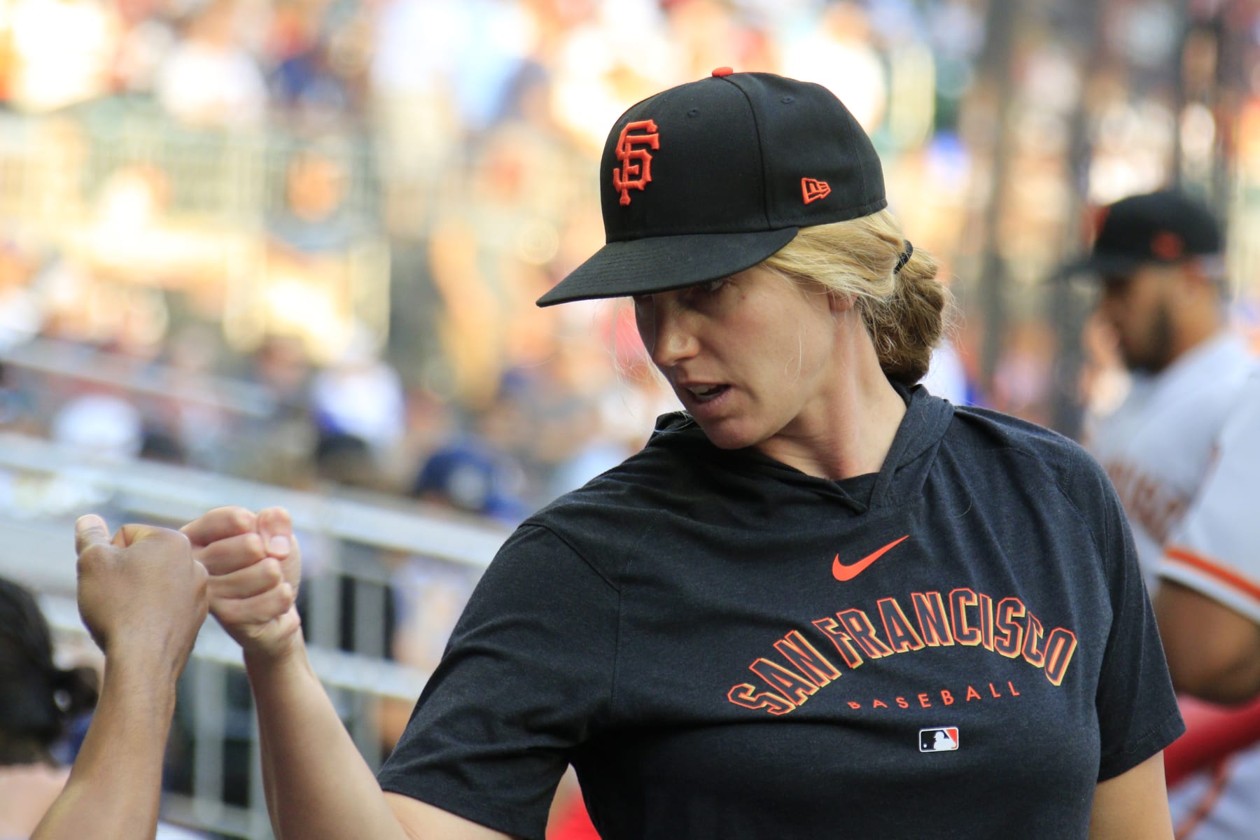 ATLANTA, GA - AUGUST 18: San Francisco Giants major league assistant coach Alyssa Nakken #92 fist bumps a player during the MLB game between the San Francisco Giants and the Atlanta Braves on August 18, 2023 at TRUIST Park in Atlanta, GA. (Photo by Jeff Robinson/Icon Sportswire via Getty Images)