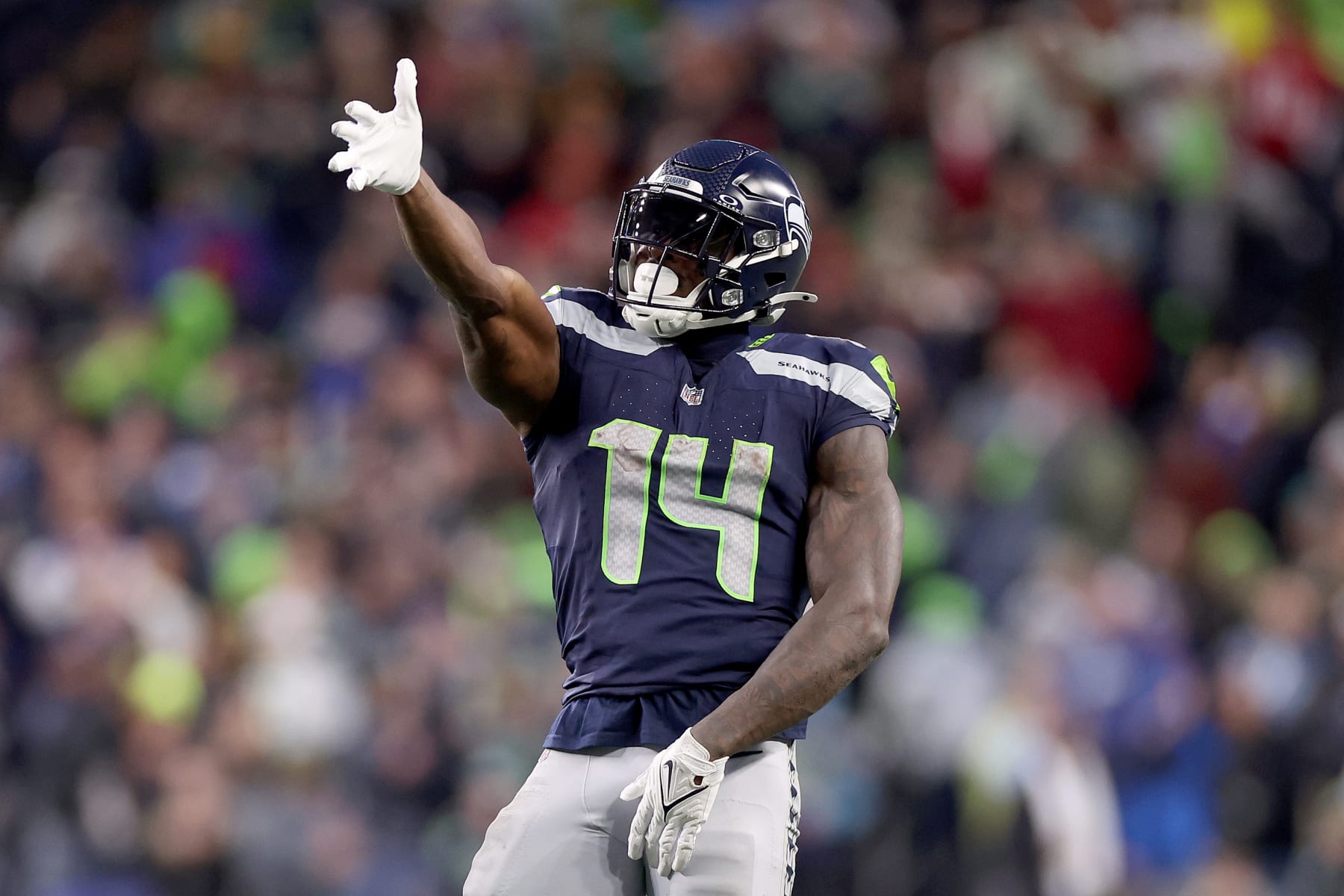 SEATTLE, WASHINGTON - NOVEMBER 12: DK Metcalf #14 of the Seattle Seahawks reacts after a first down in the fourth quarter against the Washington Commanders at Lumen Field on November 12, 2023 in Seattle, Washington. (Photo by Steph Chambers/Getty Images)