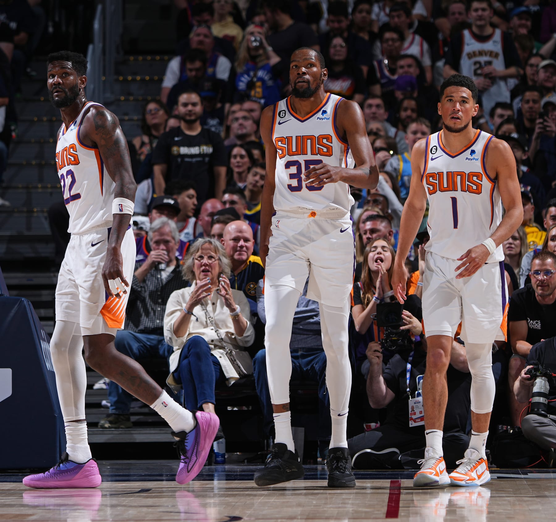 DENVER, CO - APRIL 29: Deandre Ayton #22, Kevin Durant #35, & Devin Booker #1 of the Phoenix Suns looks on during the game during round two game one of the 2023 NBA Playoffs on on April 29, 2023 at the Ball Arena in Denver, Colorado. NOTE TO USER: User expressly acknowledges and agrees that, by downloading and/or using this Photograph, user is consenting to the terms and conditions of the Getty Images License Agreement. Mandatory Copyright Notice: Copyright 2023 NBAE (Photo by Garrett Ellwood/NBAE via Getty Images)