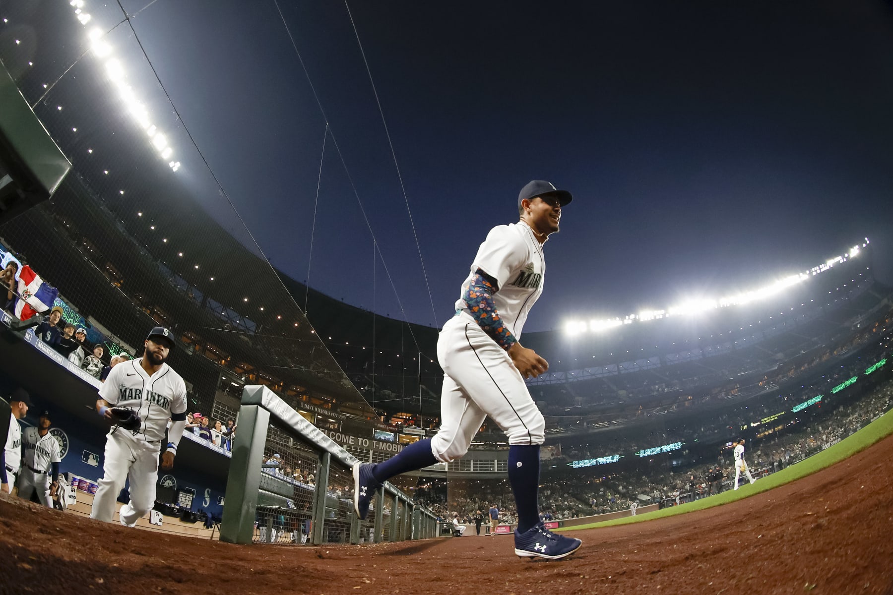 SEATTLE, WASHINGTON - OCTOBER 04: Carlos Santana #41 and Julio Rodriguez #44 of the Seattle Mariners takes the field before game two of a double header against the Detroit Tigers at T-Mobile Park on October 04, 2022 in Seattle, Washington. (Photo by Steph Chambers/Getty Images)