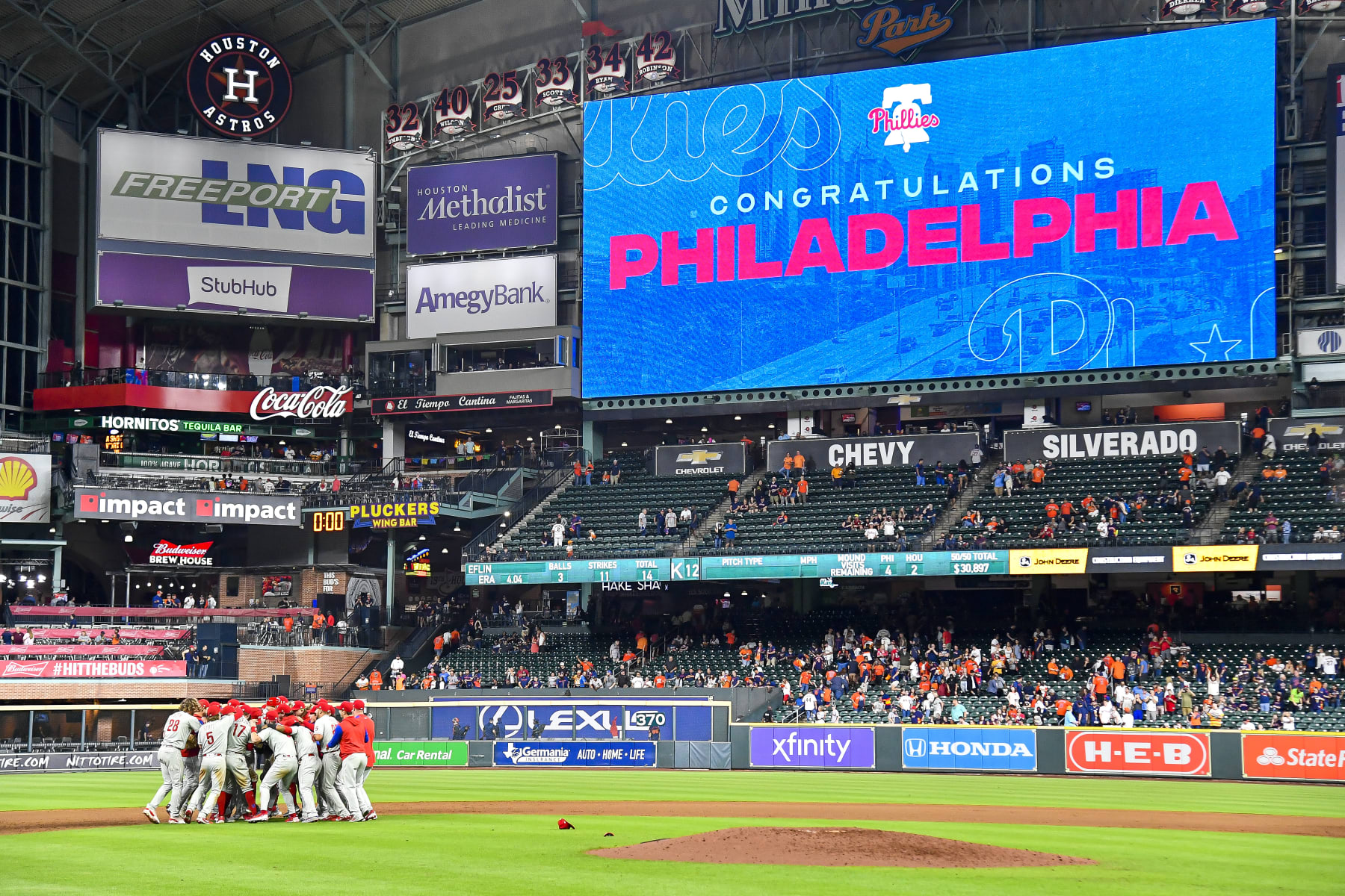 HOUSTON, TEXAS - OCTOBER 03: The Philadelphia Phillies celebrate after clinching the Wild Card, their first playoff berth since 2011 with a 3-0 win over the Houston Astros at Minute Maid Park on October 03, 2022 in Houston, Texas. (Photo by Logan Riely/Getty Images)