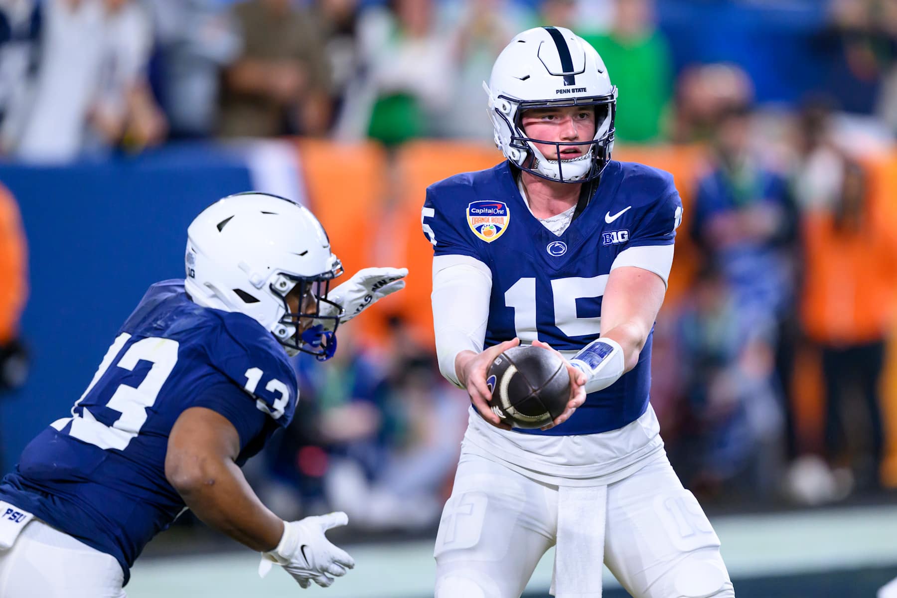 Drew Allar #15 of the Penn State Nittany Lions hands off the ball to Running Back Kaytron Allen