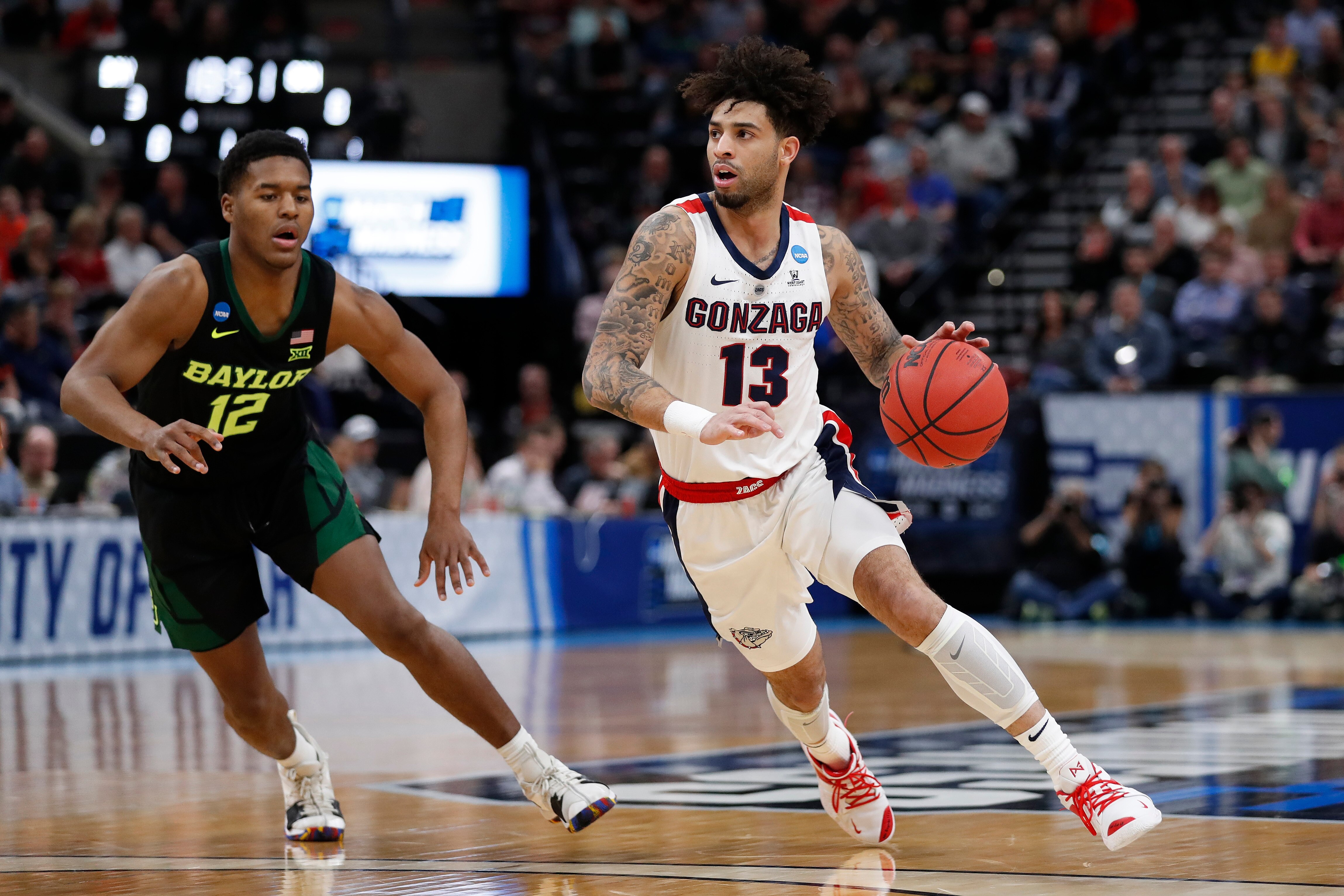 Gonzaga guard Josh Perkins (13) drives to the hoop past Baylor guard Jared Butler (12) during the first half of a second-round game in the NCAA men's college basketball tournament Saturday, March 23, 2019, in Salt Lake City. (AP Photo/Jeff Swinger)