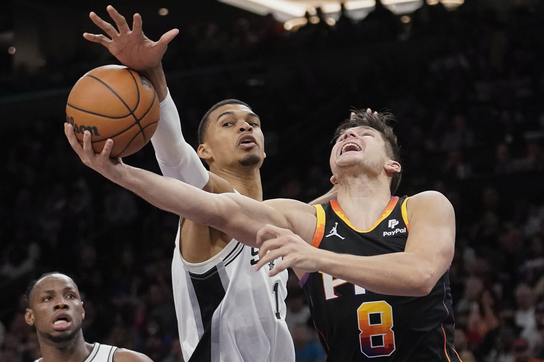 San Antonio Spurs' Victor Wembanyama (1) blocks a shot against the Phoenix Suns' Grayson Allen (8) during an NBA basketball game in Phoenix, Tuesday, Oct. 31, 2023. (AP Photo/Darryl Webb)