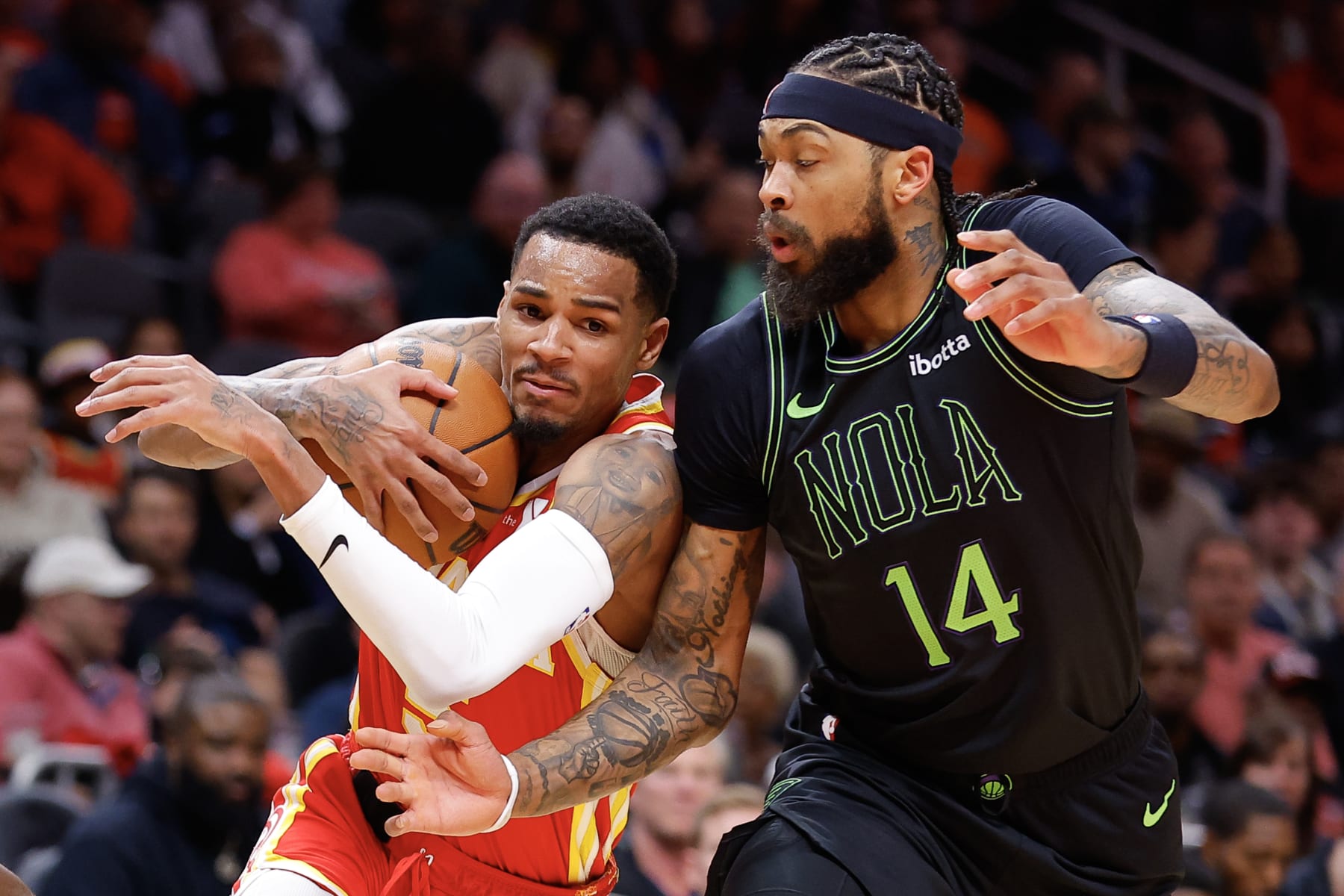 ATLANTA, GEORGIA - MARCH 10: Dejounte Murray #5 of the Atlanta Hawks drives against Brandon Ingram #14 of the New Orleans Pelicans during the second quarter at State Farm Arena on March 10, 2024 in Atlanta, Georgia. NOTE TO USER: User expressly acknowledges and agrees that, by downloading and or using this photograph, User is consenting to the terms and conditions of the Getty Images License Agreement. (Photo by Todd Kirkland/Getty Images)