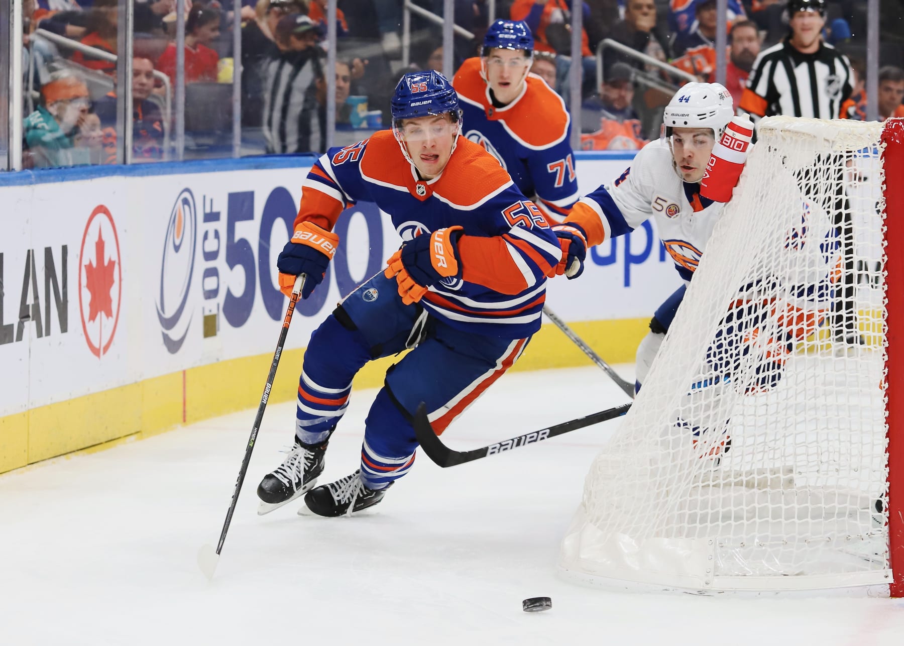 EDMONTON, CANADA - JANUARY 5: Dylan Holloway #55 of the Edmonton Oilers pursues the puck behind the net in the third period against the New York Islanders on January 5, 2023 at Rogers Place in Edmonton, Alberta, Canada. (Photo by Lawrence Scott/Getty Images)