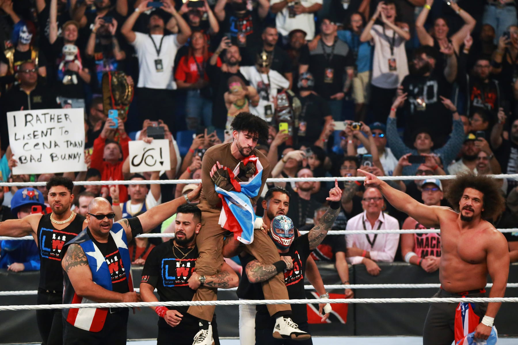 SAN JUAN, PUERTO RICO - MAY 06: Bad Bunny celebrates his victory on the ring with LWO, Savio Vega (L) and Carlito Caribbean Cool (R) during the WWE Backlash at Coliseo de Puerto Rico José Miguel Agrelot on May 06, 2023 in San Juan, Puerto Rico.(Photo by Gladys Vega/ Getty Images)