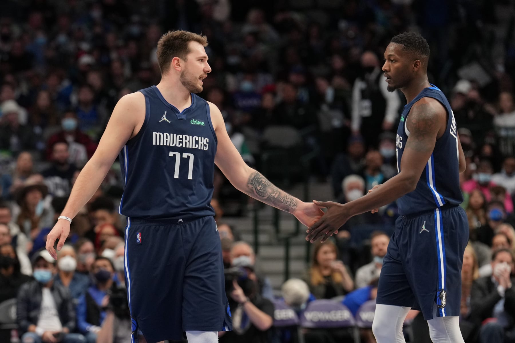 DALLAS, TX - JANUARY 29: Luka Doncic #77 and Dorian Finney-Smith #10 of the Dallas Mavericks high five during the game against Indiana Pacers on January 29, 2022 at the American Airlines Center in Dallas, Texas. NOTE TO USER: User expressly acknowledges and agrees that, by downloading and or using this photograph, User is consenting to the terms and conditions of the Getty Images License Agreement. Mandatory Copyright Notice: Copyright 2022 NBAE (Photo by Glenn James/NBAE via Getty Images)