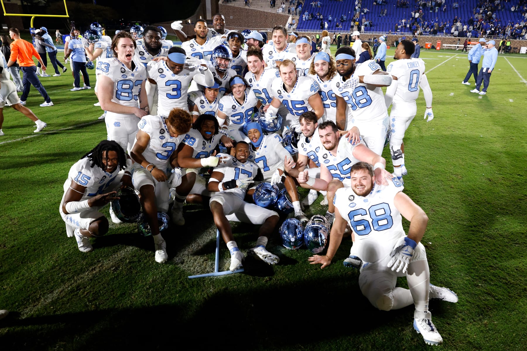 DURHAM, NC - OCTOBER 15: Players of the North Carolina Tar Heels celebrate following their 38-35 victory against the Duke Blue Devils at Wallace Wade Stadium on October 15, 2022 in Durham, North Carolina. (Photo by Lance King/Getty Images)