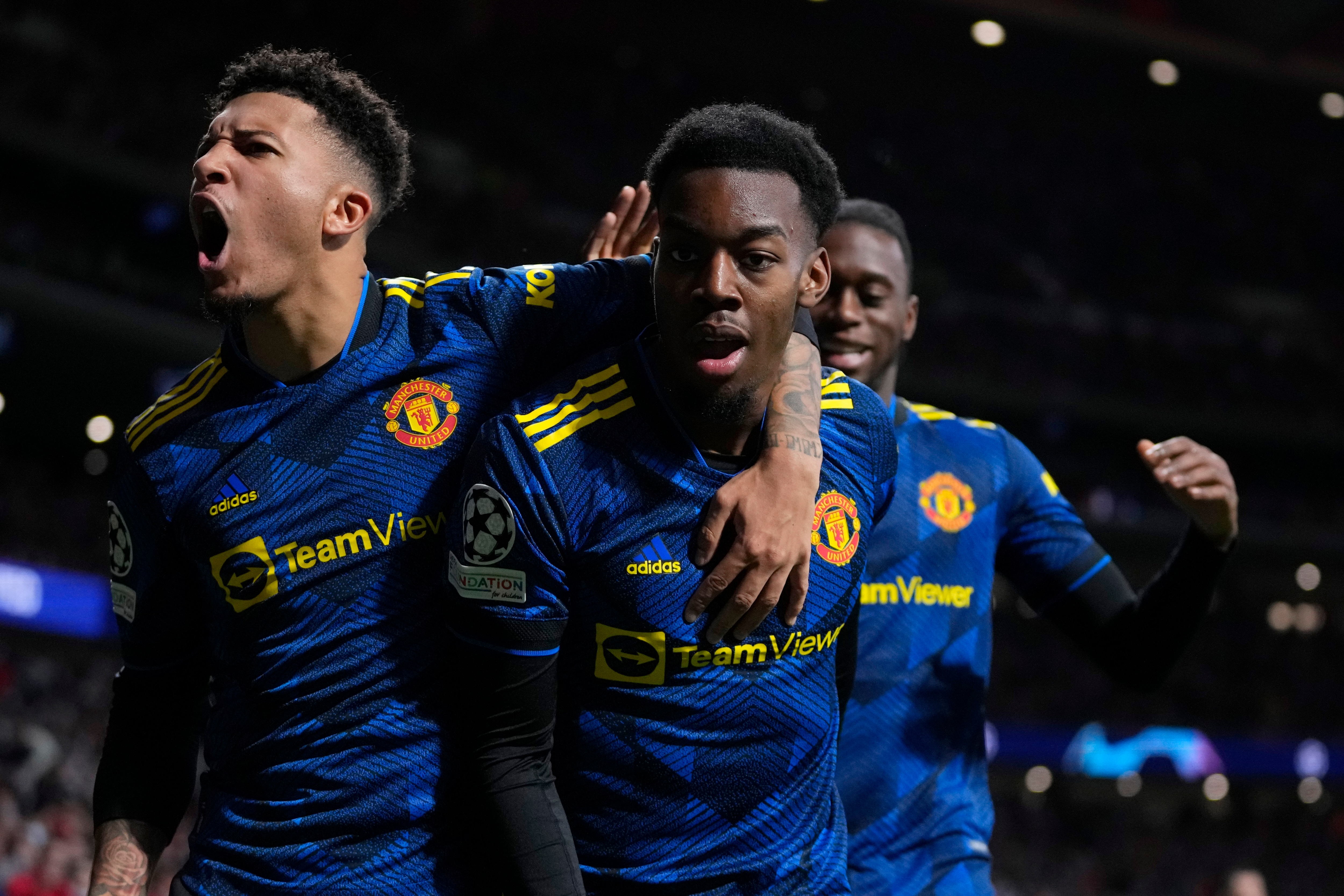 Manchester United's Anthony Elanga, center, celebrates after scoring his side's first goal during the Champions League, round of 16, first leg soccer match between Atletico Madrid and Manchester United at the Wanda Metropolitano stadium in Madrid, Spain, Wednesday, Feb. 23, 2022. (AP Photo/Manu Fernandez)