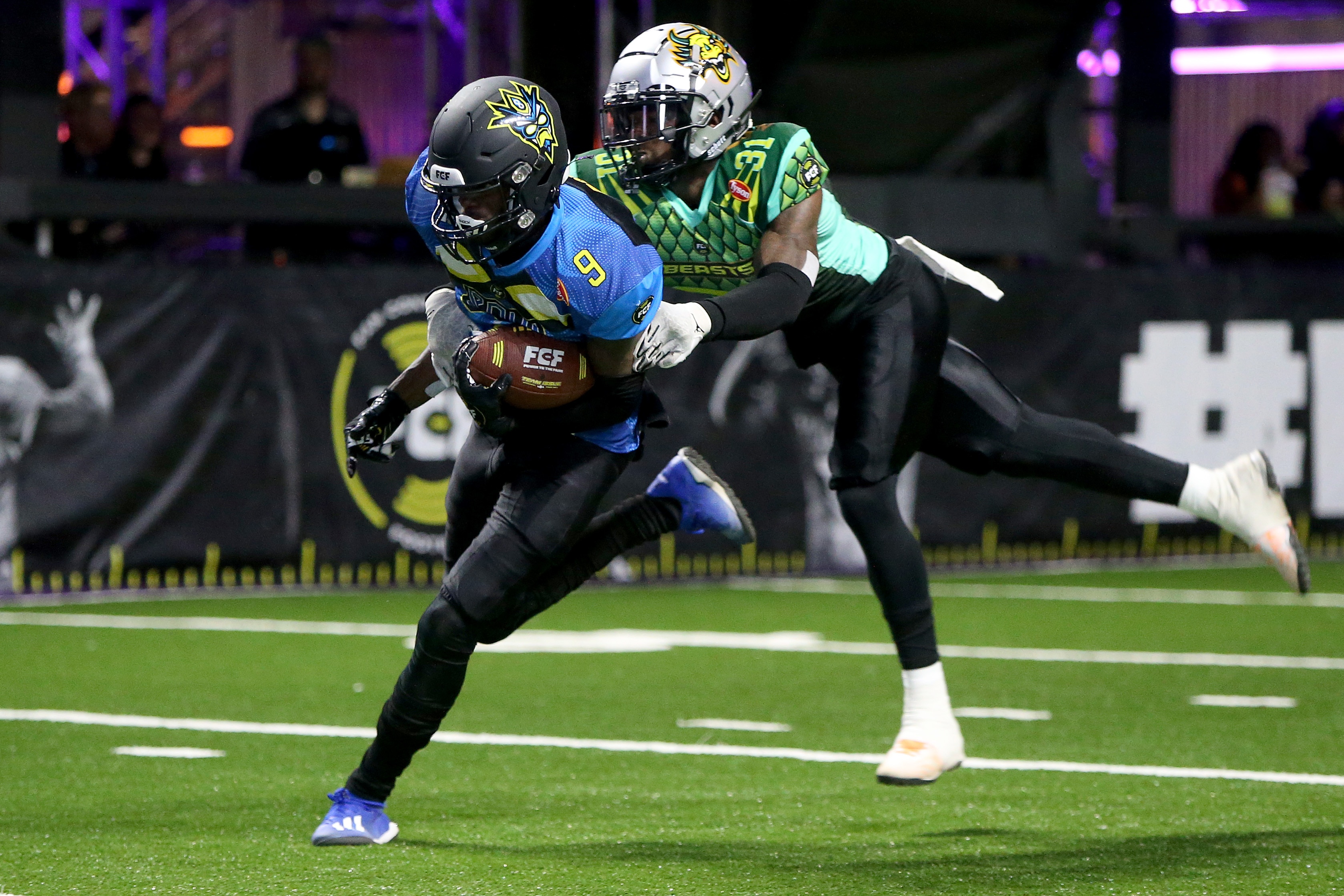 ATLANTA, GEORGIA - APRIL 30: Joseph Boykin #9 of the 8OKI scores a touchdown past Dashawn Benton #31 of the Beasts during the second half during Fan Controlled Football Season v2.0 - Week Three on April 30, 2022 in Atlanta, Georgia. (Photo by Brett Davis/Fan Controlled Football/Getty Images)