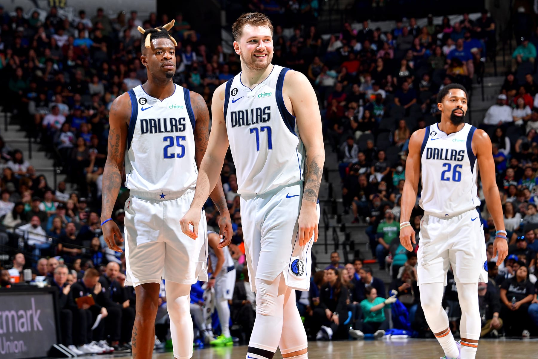 SAN ANTONIO, TX - DECEMBER 31: Reggie Bullock #25, Luka Doncic #77 and Spencer Dinwiddie #26 of the Dallas Mavericks smiles during the game against the San Antonio Spurs  on December 31, 2022 at the AT&T Center in San Antonio, Texas. NOTE TO USER: User expressly acknowledges and agrees that, by downloading and or using this photograph, user is consenting to the terms and conditions of the Getty Images License Agreement. Mandatory Copyright Notice: Copyright 2022 NBAE (Photos by Michael Gonzales/NBAE via Getty Images)