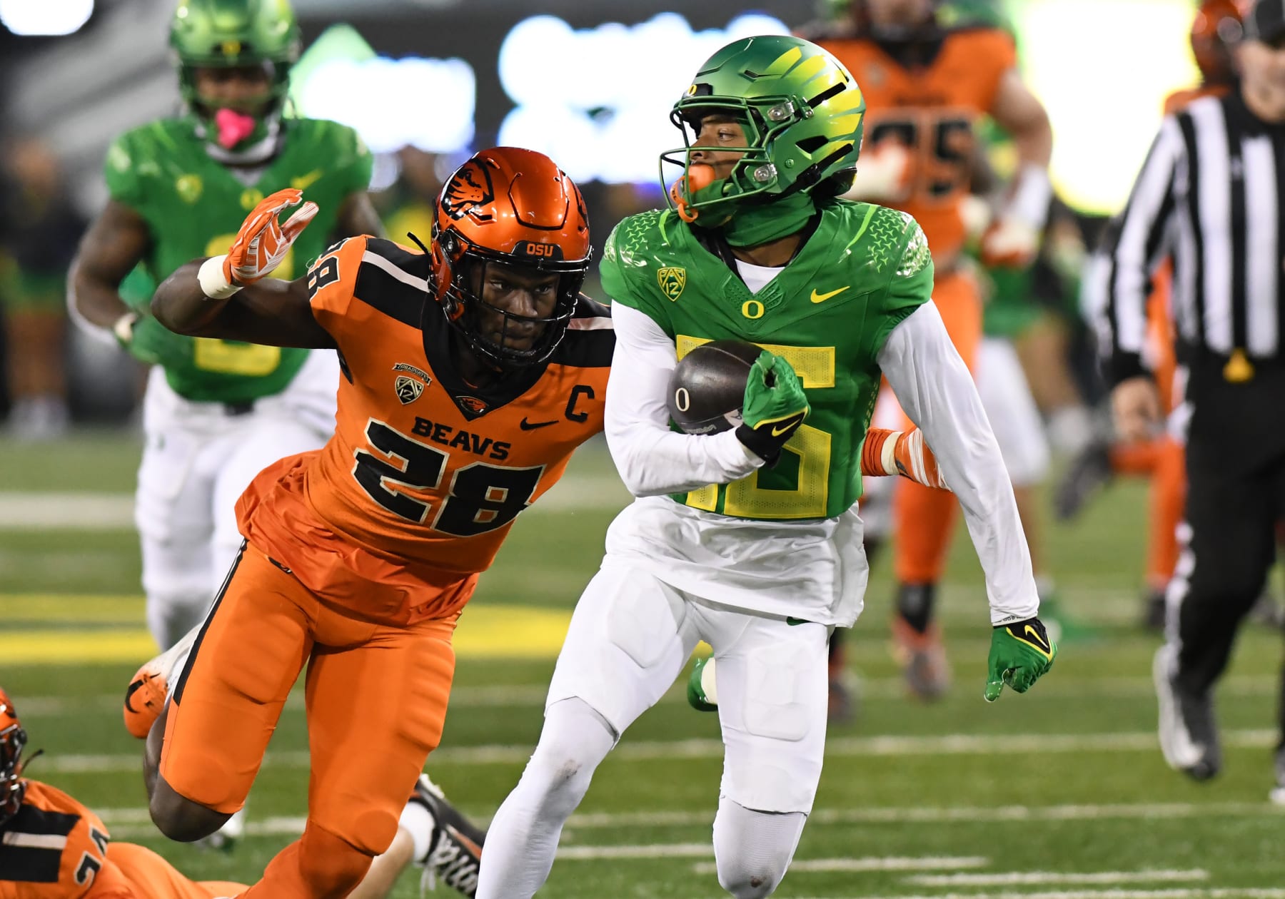 EUGENE, OR - NOVEMBER 24: Oregon Ducks wide receiver Tez Johnson (15) runs after the catch against Oregon State Beavers defensive back Kitan Oladapo (28) during a college football game between the Oregon Ducks and Oregon State Beavers on November 24, 2023, at Autzen Stadium in Eugene, Oregon. (Photo by Brian Murphy/Icon Sportswire via Getty Images)
