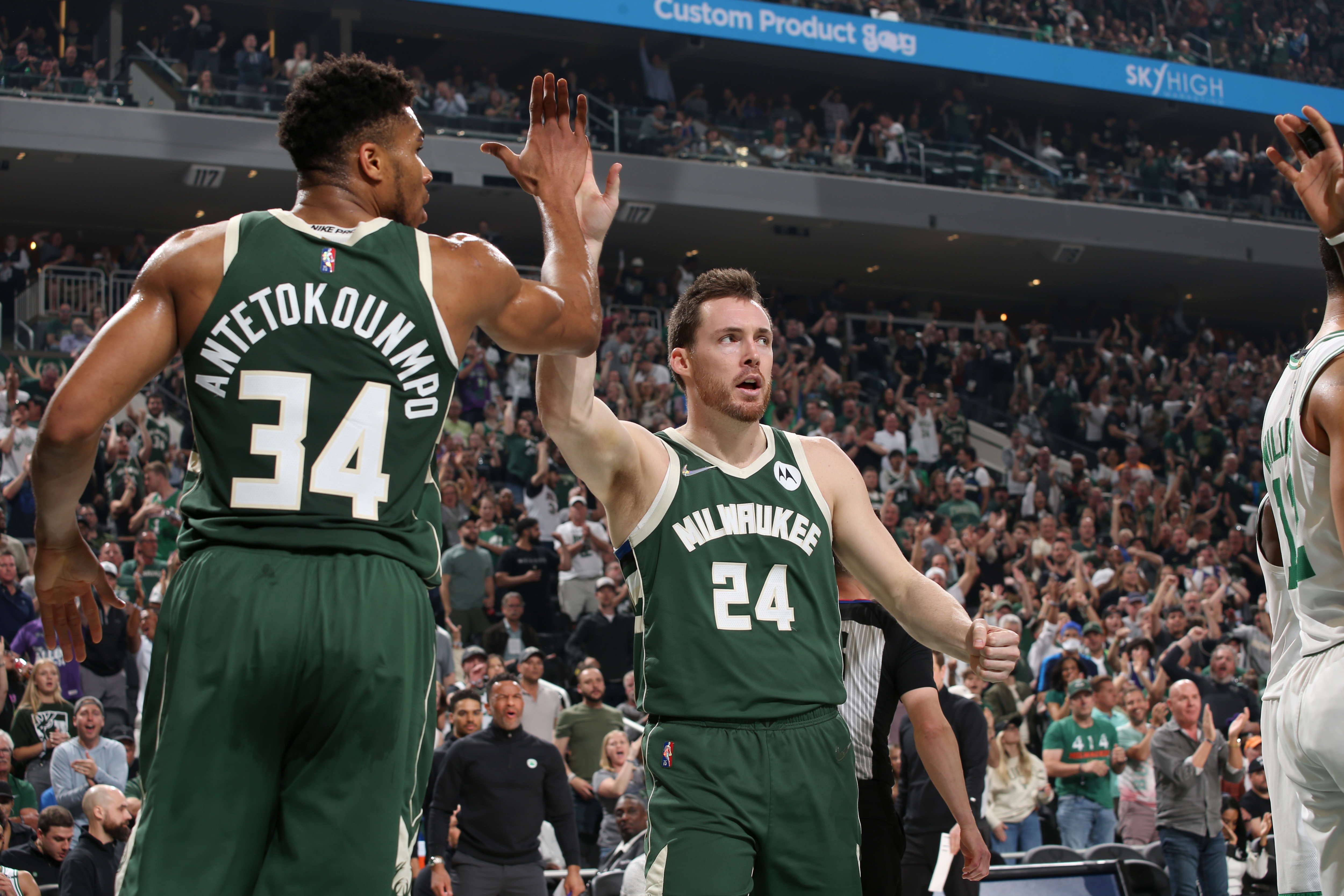 MILWAUKEE, WI - MAY 13: Pat Connaughton #24 of the Milwaukee Bucks high fives Giannis Antetokounmpo #34 of the Milwaukee Bucks during the game against the Boston Celtics during Game 6 of the 2022 NBA Playoffs Eastern Conference Semifinals on May 13, 2022 at the Fiserv Forum Center in Milwaukee, Wisconsin. NOTE TO USER: User expressly acknowledges and agrees that, by downloading and or using this Photograph, user is consenting to the terms and conditions of the Getty Images License Agreement. Mandatory Copyright Notice: Copyright 2022 NBAE (Photo by Gary Dineen/NBAE via Getty Images).