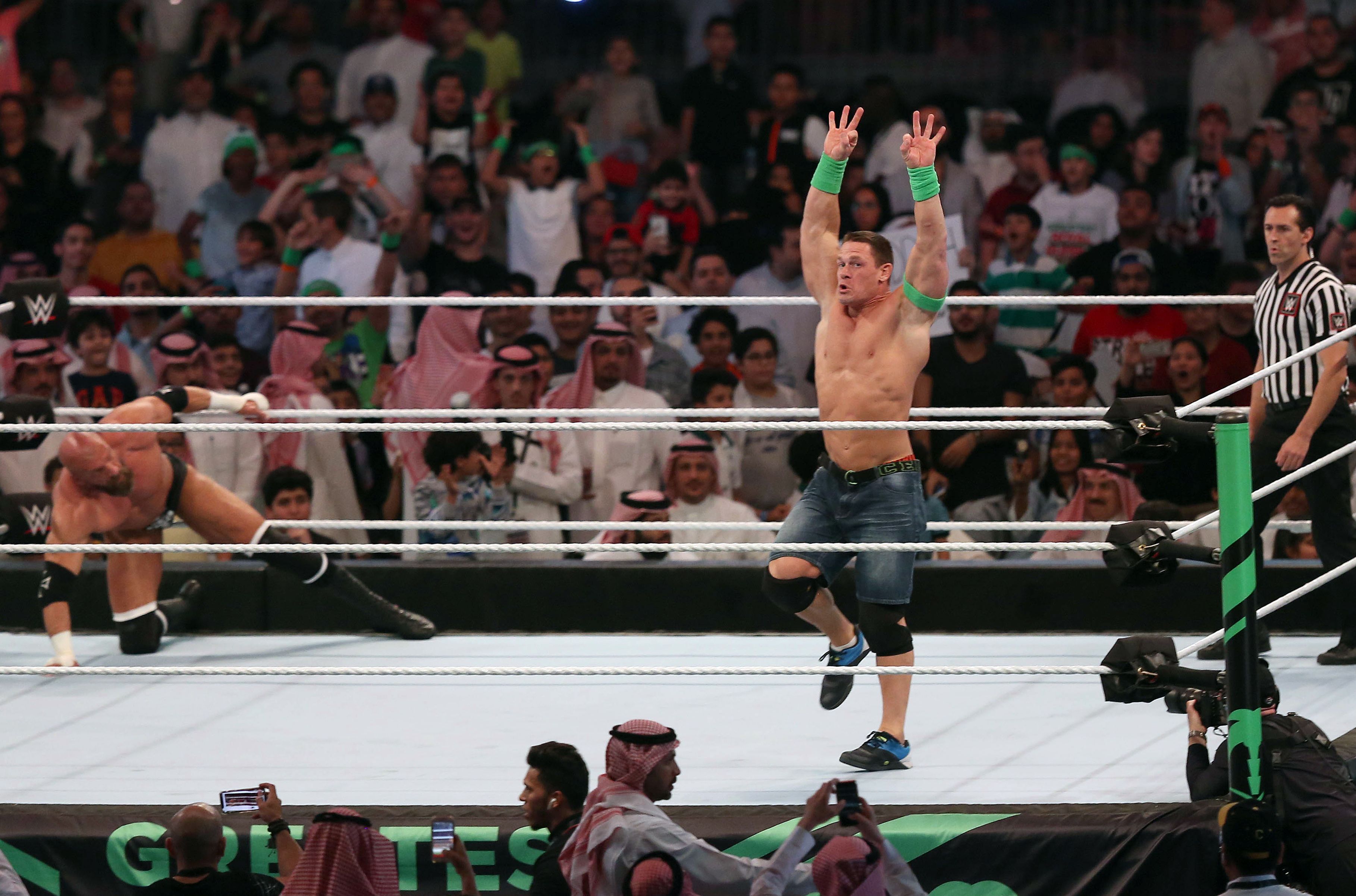 John Cena (R) competes with Triple H (L) during the World Wrestling Entertainment (WWE) Greatest Royal Rumble event in the Saudi coastal city of Jeddah on April 27, 2018. (Photo by STRINGER / AFP)        (Photo credit should read STRINGER/AFP via Getty Images)