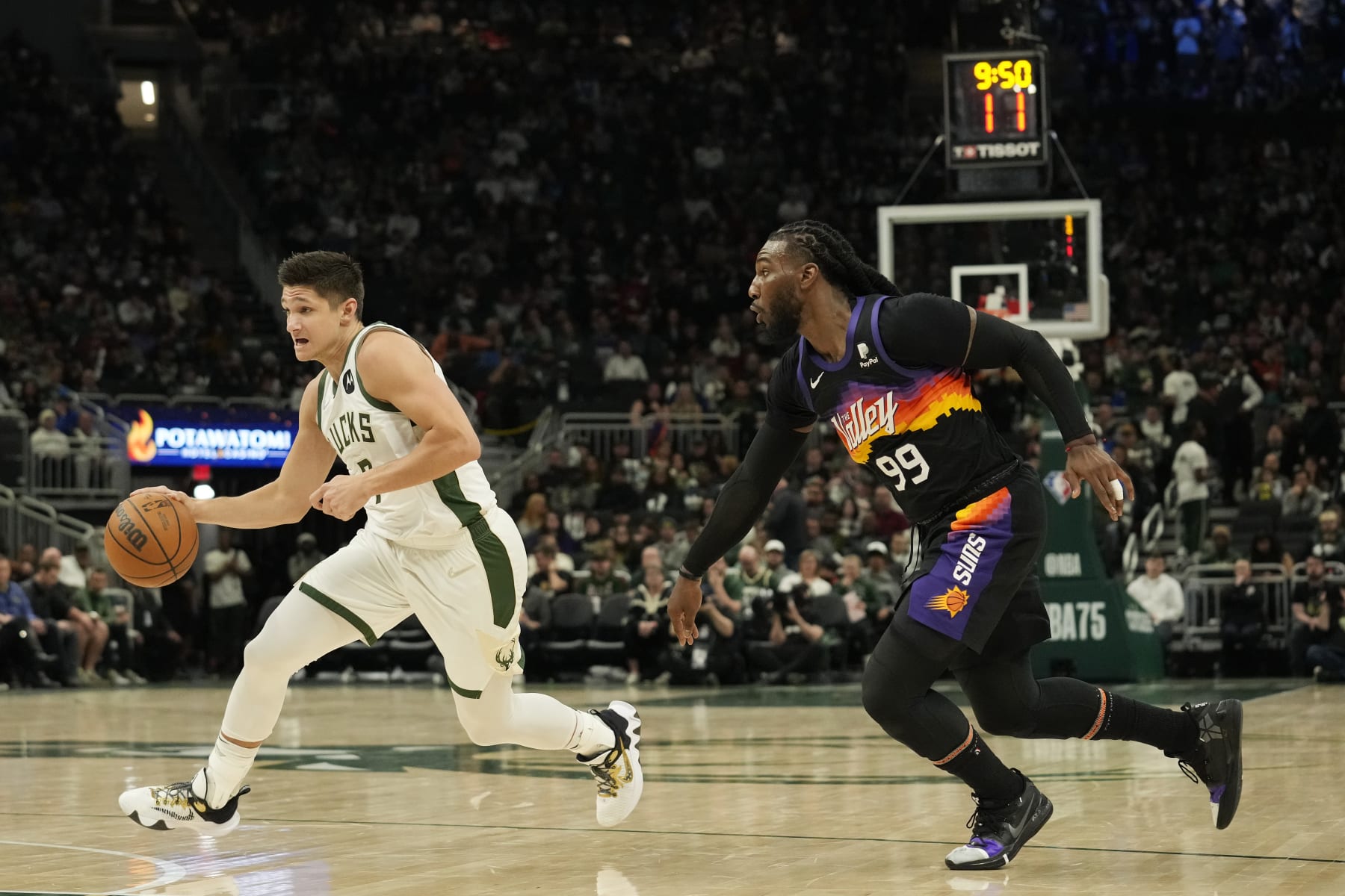 MILWAUKEE, WISCONSIN - MARCH 06: Grayson Allen #7 of the Milwaukee Bucks dribbles the ball against Jae Crowder #99 of the Phoenix Suns during the second half at Fiserv Forum on March 06, 2022 in Milwaukee, Wisconsin. The Milwaukee Bucks defeated the Phoenix Suns 132-122. NOTE TO USER: User expressly acknowledges and agrees that, by downloading and or using this photograph, User is consenting to the terms and conditions of the Getty Images License Agreement. (Photo by Patrick McDermott/Getty Images)