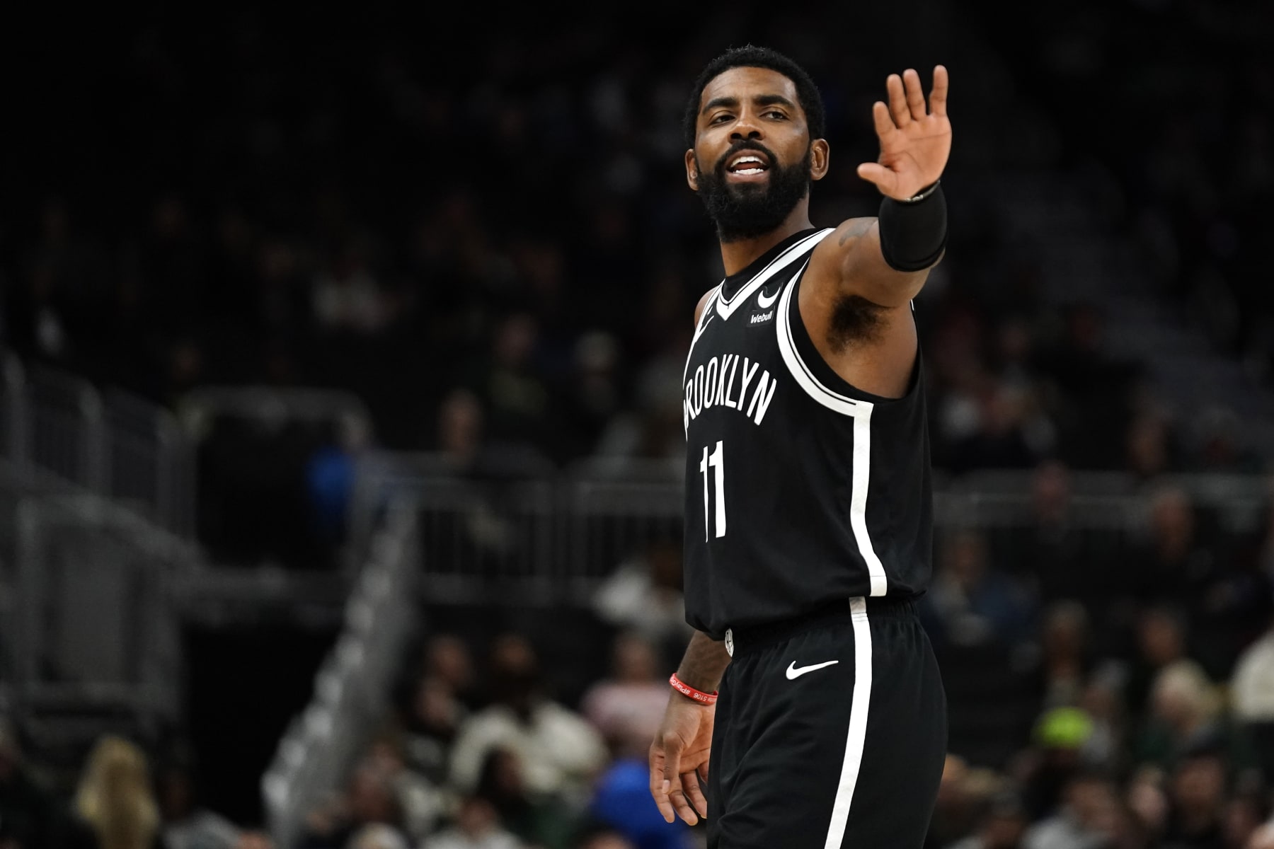 Brooklyn Nets' Kyrie Irving gestures to teammates during the second half of an NBA preseason basketball game against the Milwaukee Bucks Wednesday, Oct. 12, 2022, in Milwaukee. (AP Photo/Aaron Gash)