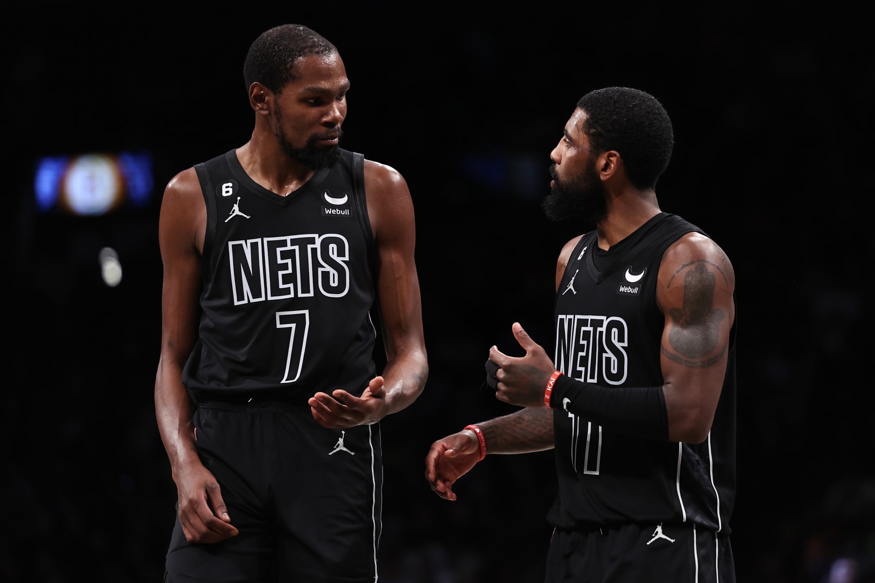 NEW YORK, NEW YORK - OCTOBER 31: Kyrie Irving #11 and Kevin Durant #7 of the Brooklyn Nets talk during a break in the action during the fourth quarter of the game against the Indiana Pacers at Barclays Center on October 31, 2022 in New York City. NOTE TO USER: User expressly acknowledges and agrees that, by downloading and or using this photograph, User is consenting to the terms and conditions of the Getty Images License Agreement. (Photo by Dustin Satloff/Getty Images)