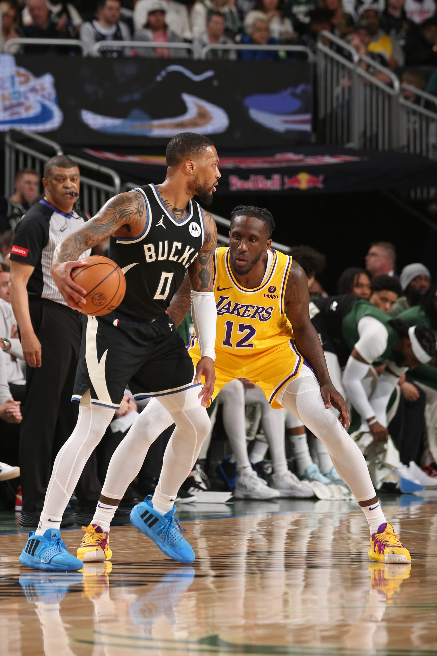 MILWAUKEE, WI - MARCH 26:  Taurean Prince #12 of the Los Angeles Lakers plays defense during the game  plays defense during the game  against Damian Lillard #0 of the Milwaukee Bucks on March 26, 2024 at the Fiserv Forum Center in Milwaukee, Wisconsin. NOTE TO USER: User expressly acknowledges and agrees that, by downloading and or using this Photograph, user is consenting to the terms and conditions of the Getty Images License Agreement. Mandatory Copyright Notice: Copyright 2024 NBAE (Photo by Gary Dineen/NBAE via Getty Images).
