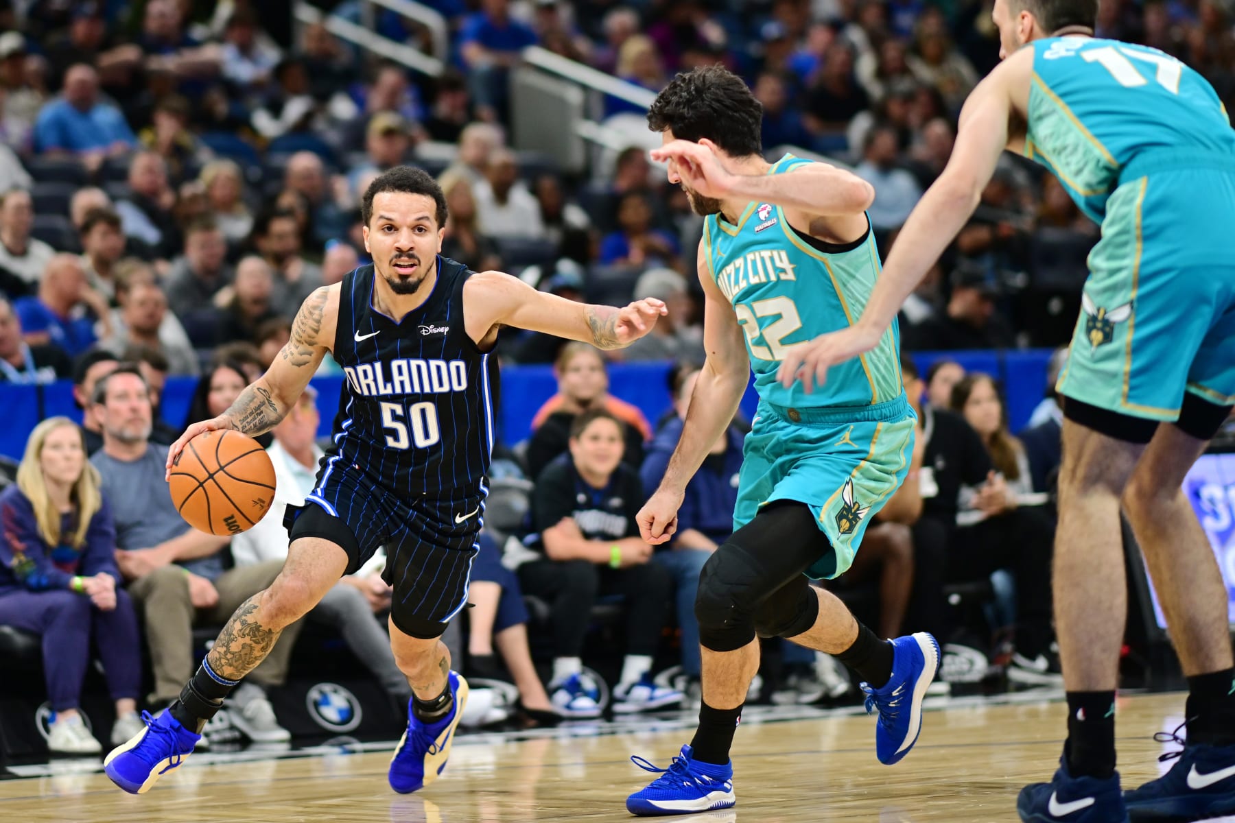 ORLANDO, FLORIDA - MARCH 19: Cole Anthony #50 of the Orlando Magic drives to the basket against Vasilije Micic #22 of the Charlotte Hornets in the first half of a game at Kia Center on March 19, 2024 in Orlando, Florida. NOTE TO USER: User expressly acknowledges and agrees that, by downloading and or using this photograph, User is consenting to the terms and conditions of the Getty Images License Agreement. (Photo by Julio Aguilar/Getty Images)