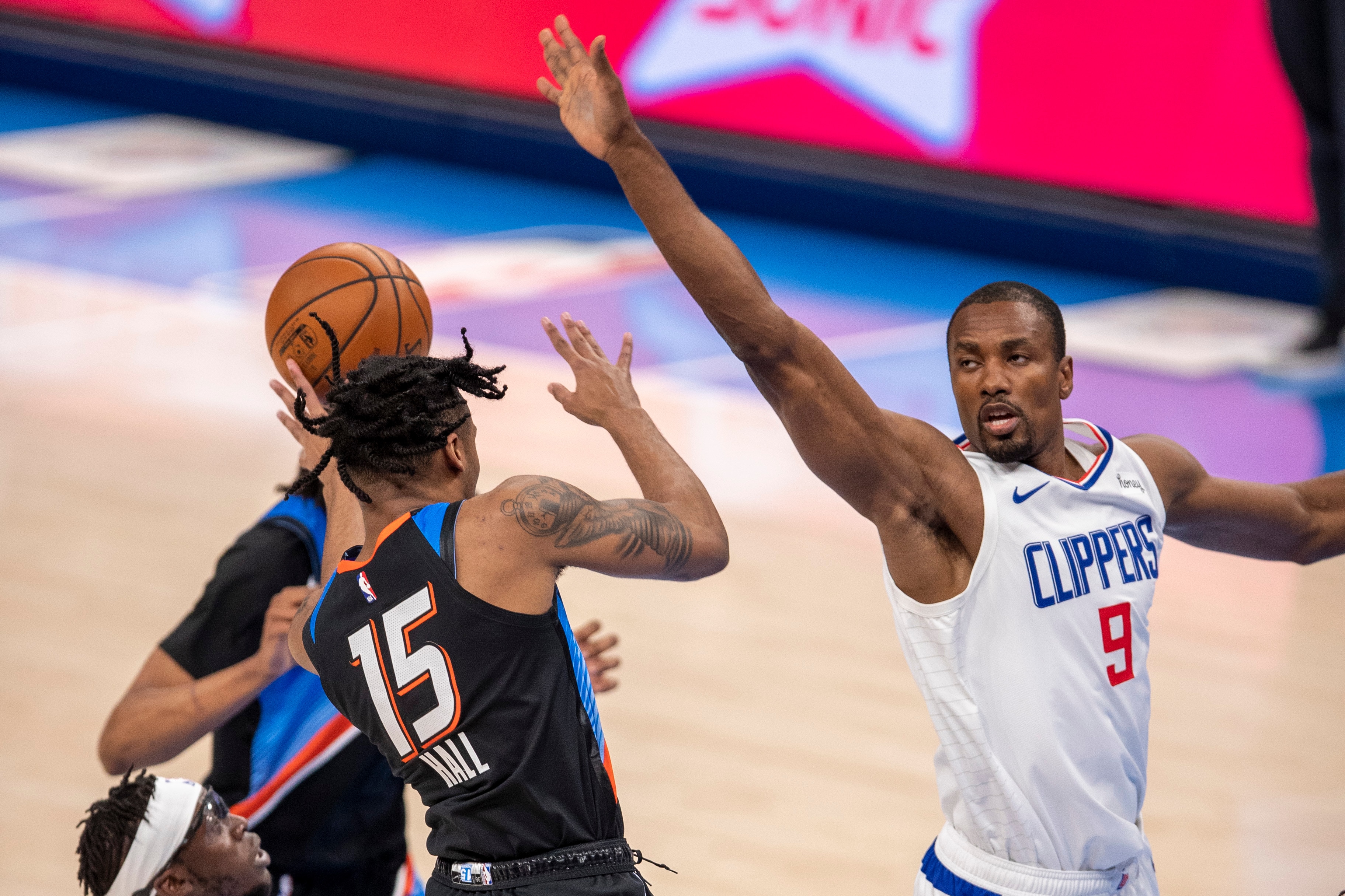 OKLAHOMA CITY, OKLAHOMA - MAY 14:  Serge Ibaka #9 of the Los Angeles Clippers defends Josh Hall #15 of the Oklahoma City Thunder at Chesapeake Energy Arena on May 14, 2021 in Oklahoma City, Oklahoma. NOTE TO USER:  User expressly acknowledges and agrees that, by downloading and or using this photograph, User is consenting to the terms and conditions of the Getty Images License Agreement.  (Photo by Wesley Hitt/Getty Images)