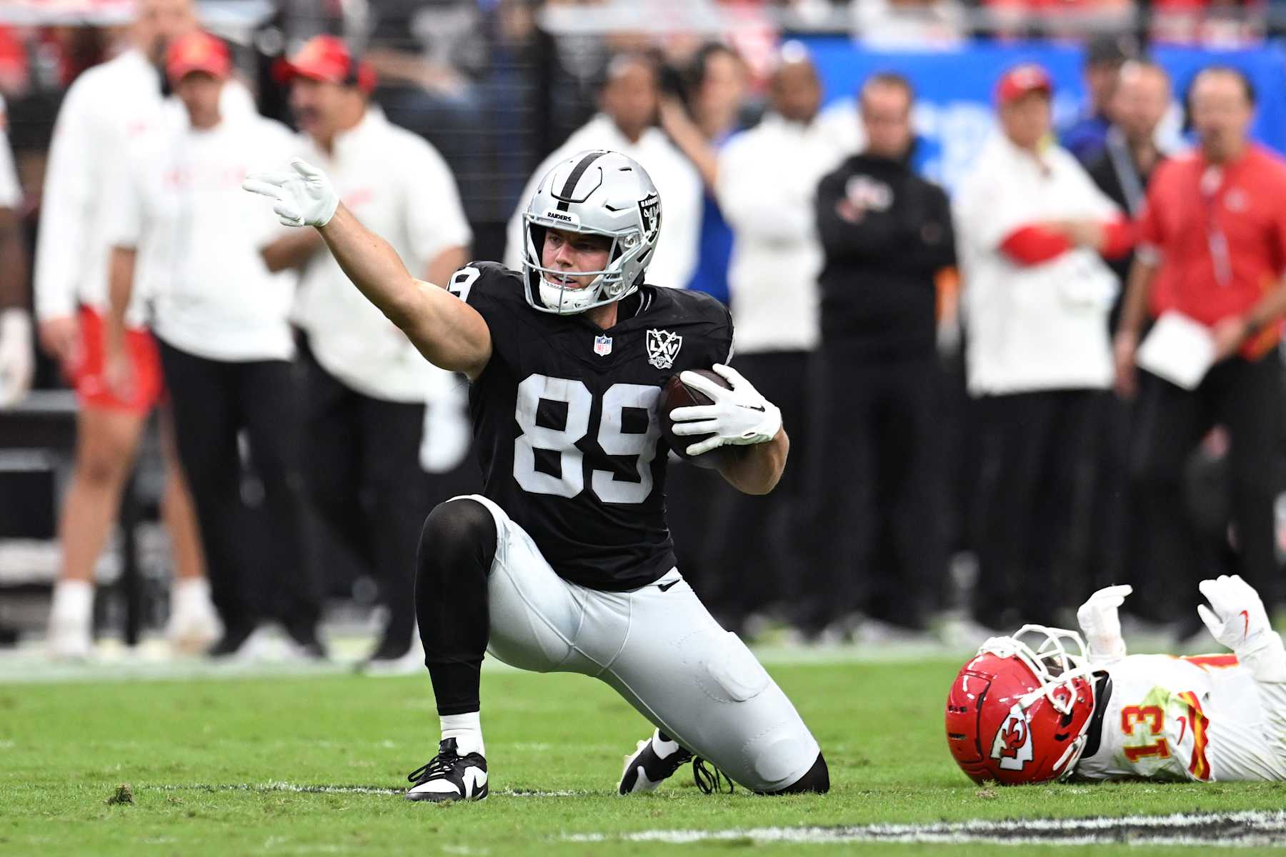 LAS VEGAS, NEVADA - OCTOBER 27: Brock Bowers #89 of the Las Vegas Raiders signals for a first down after a making a catch against Nazeeh Johnson #13 of the Kansas City Chiefs in the second quarter of a game at Allegiant Stadium on October 27, 2024 in Las Vegas, Nevada. (Photo by Candice Ward/Getty Images)