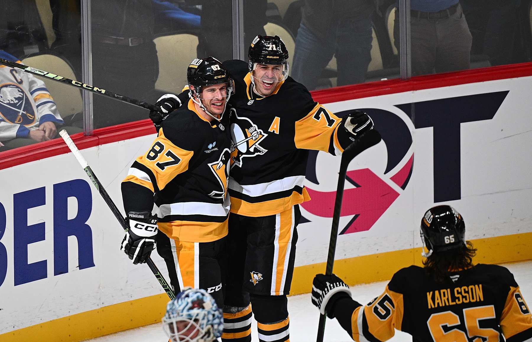 PITTSBURGH, PENNSYLVANIA - OCTOBER 16: Sidney Crosby #87 of the Pittsburgh Penguins celebrates with Evgeni Malkin #71 after scoring the game winning goal in overtime to give the Penguins a 6-5 win over the Buffalo Sabres at PPG PAINTS Arena on October 16, 2024 in Pittsburgh, Pennsylvania. (Photo by Justin Berl/Getty Images)